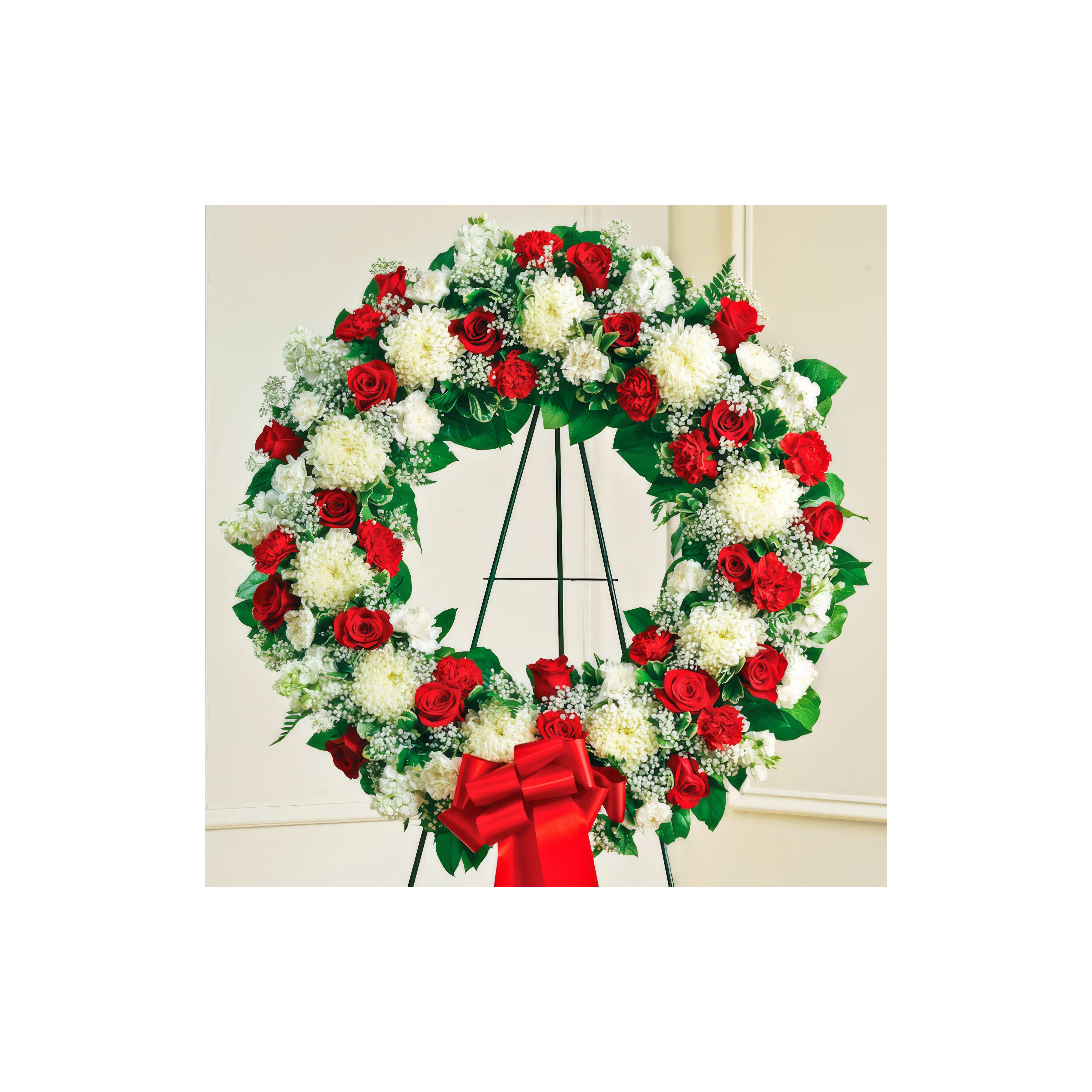 Stunning wreath of red roses and white flowers, ideal for memorials and tributes.