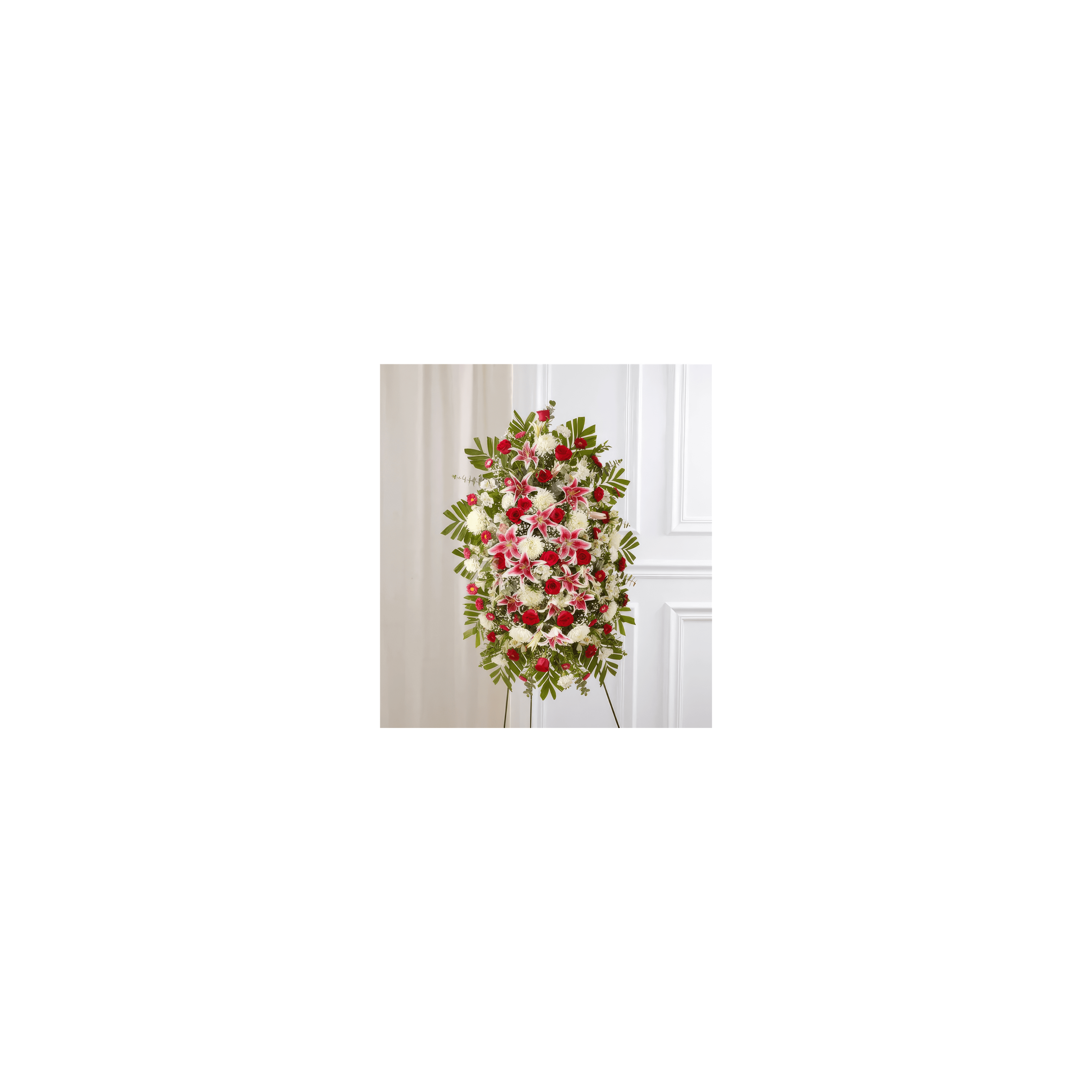 Colorful flowers including red roses and white lilies beautifully arranged on a stand indoors.