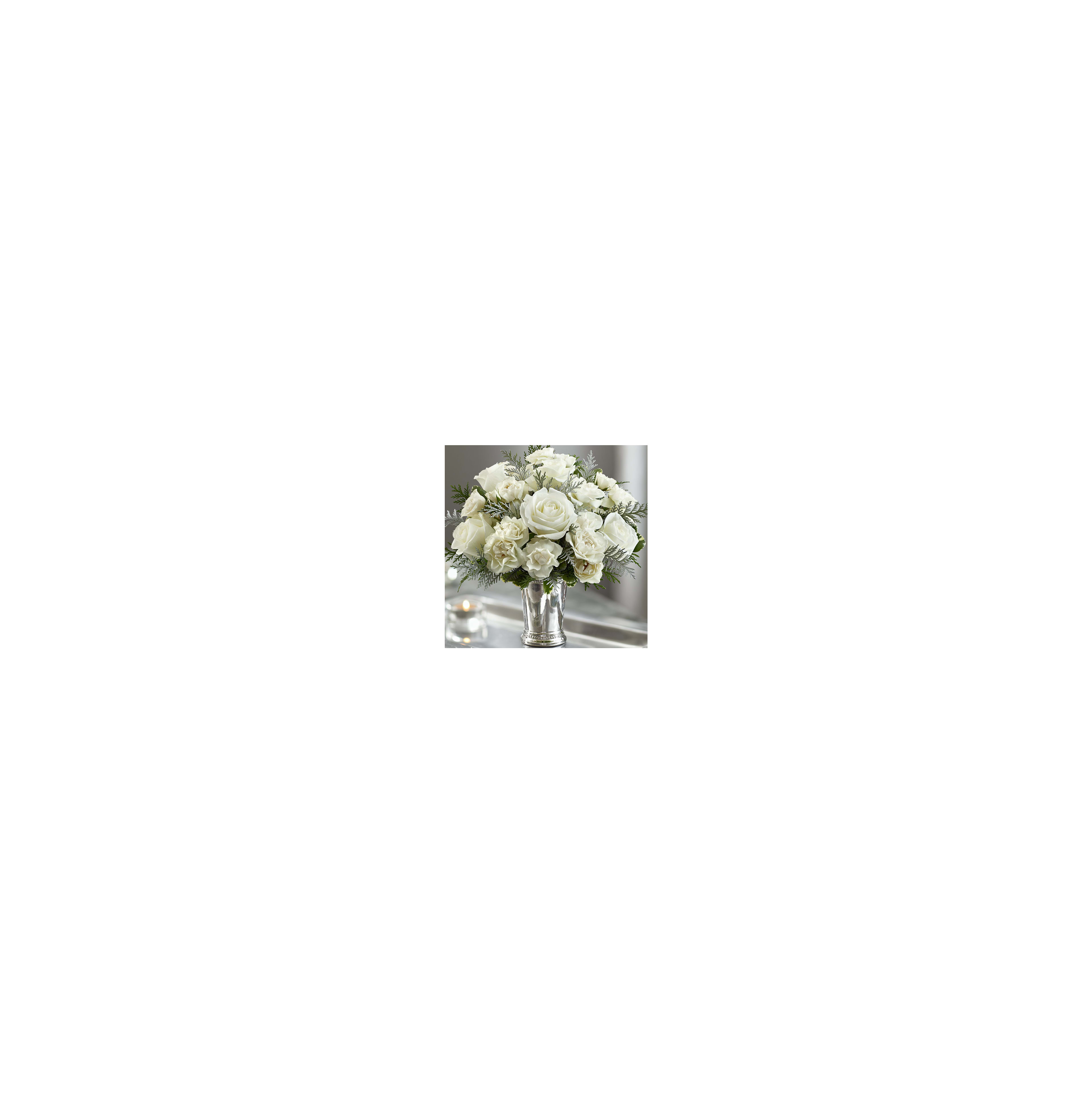 A beautiful arrangement of white roses and greenery adorns a silver vase on a table.