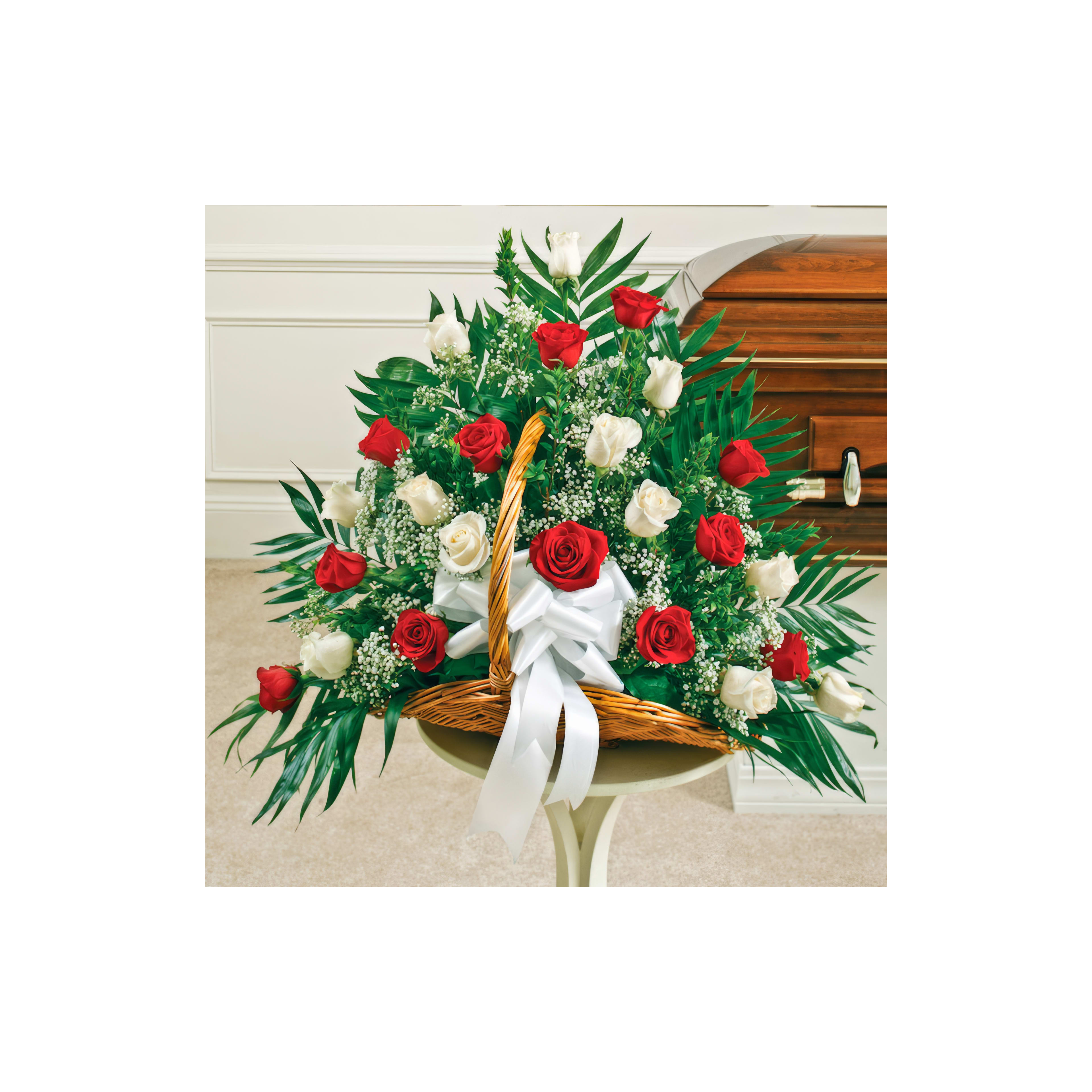 Beautiful arrangement of red and white roses with greenery, perfect for a celebration or tribute.