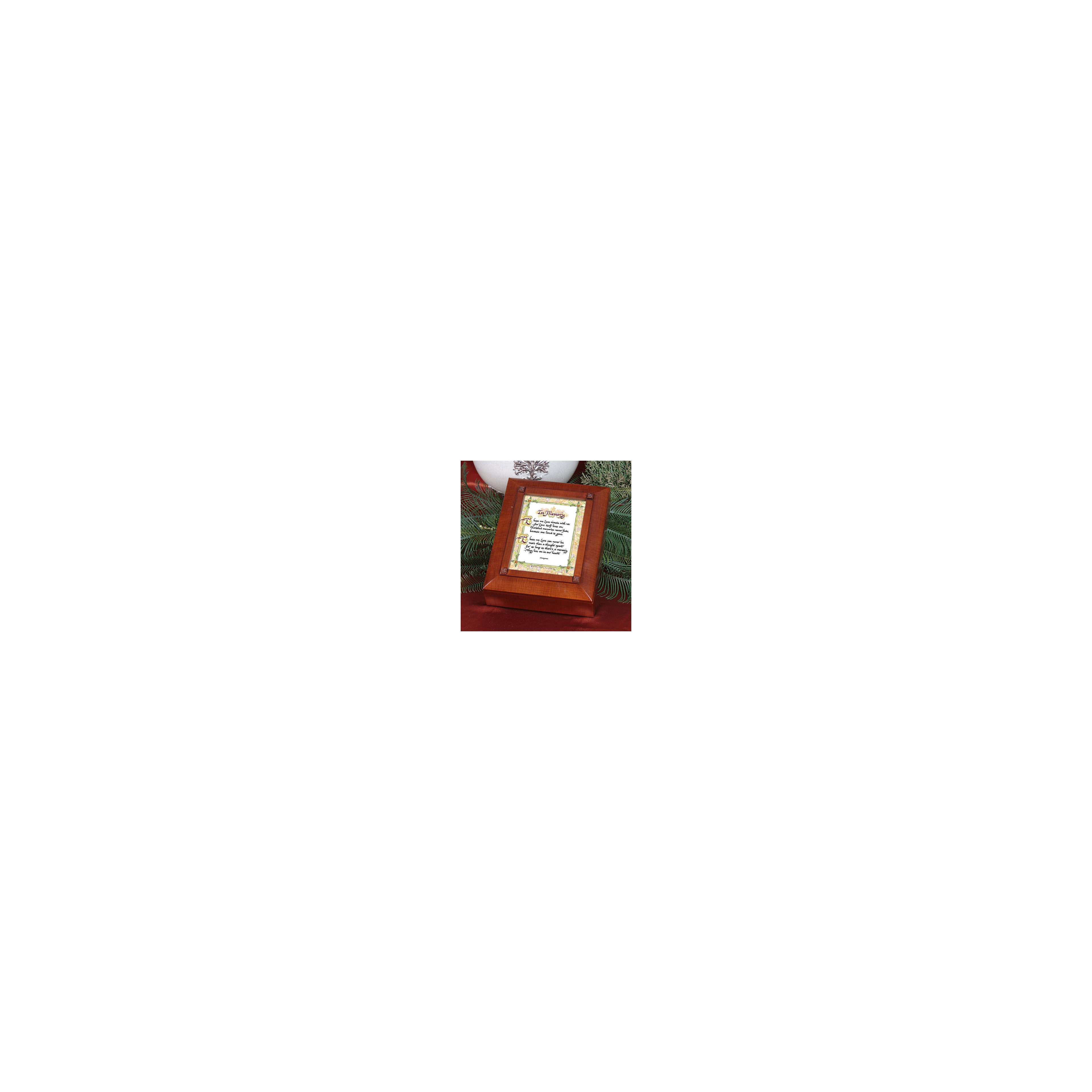A wooden box holds a touching tribute, surrounded by pine branches, evoking cherished memories.