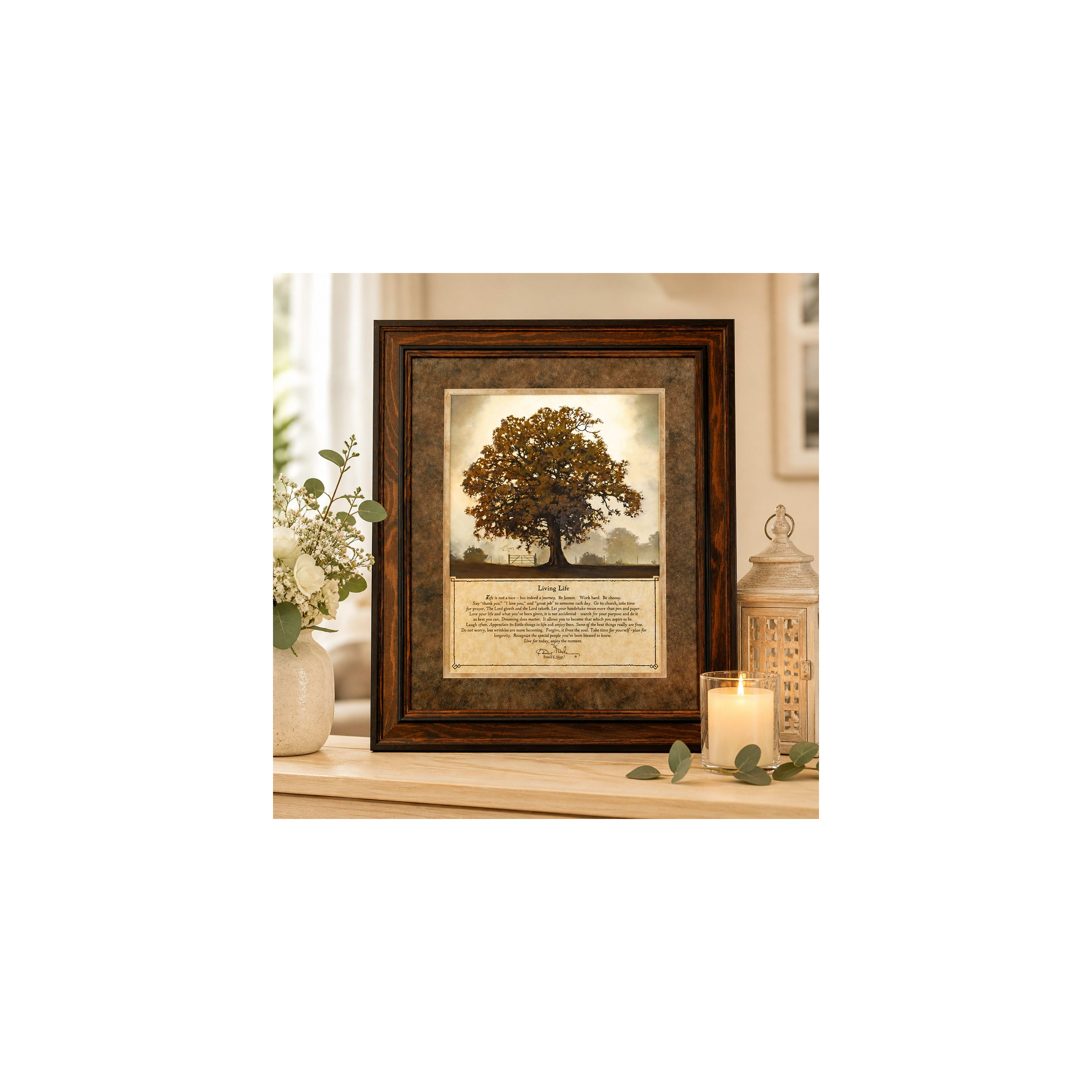 A framed picture of a tree and a candle