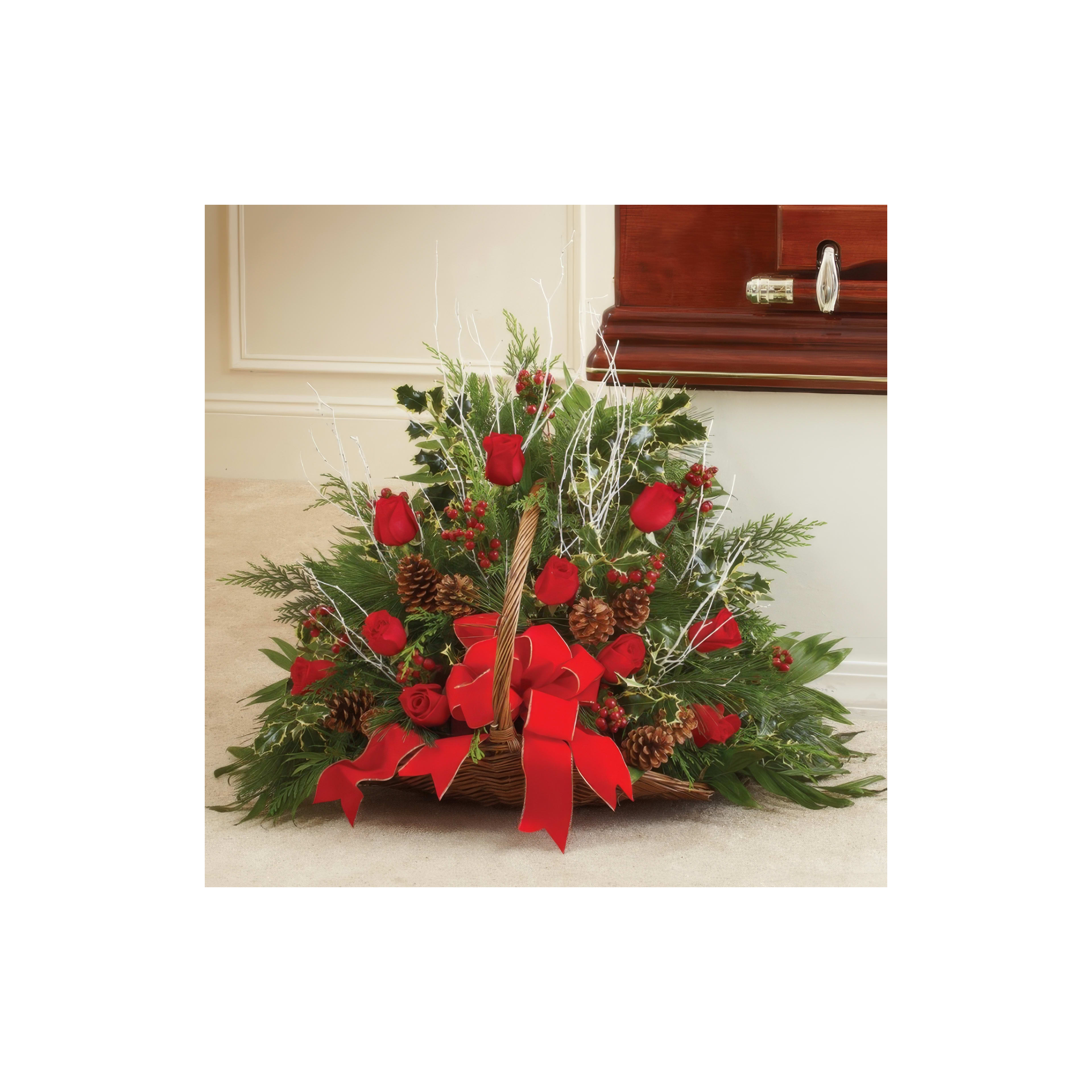 Vibrant arrangement of red roses, pinecones, and greenery in a basket, perfect for celebrations.