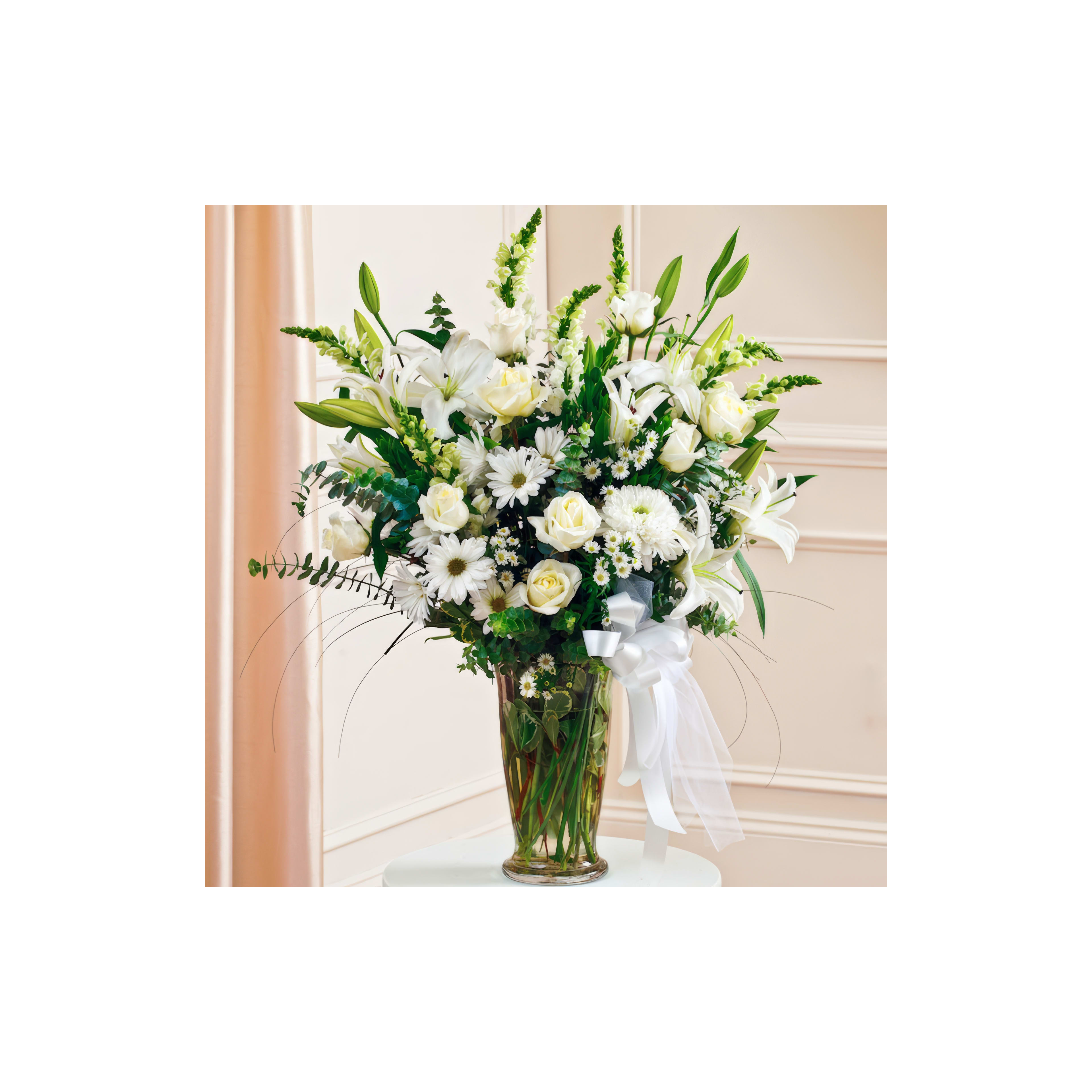 Beautiful bouquet composed of white lilies, roses, and daisies arranged in an elegant vase.