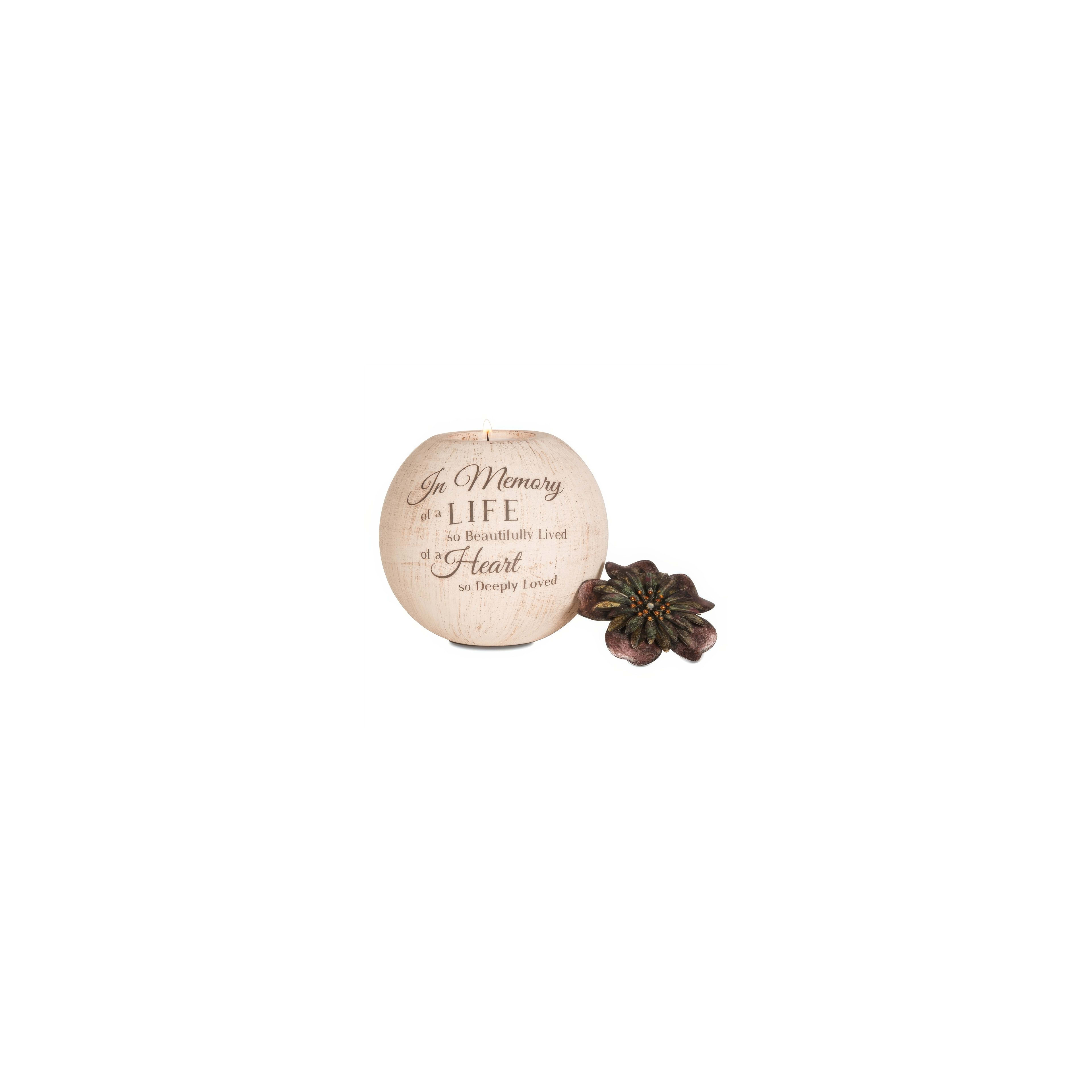 A candle holder honors a cherished life with a touching message and a decorative flower beside it.