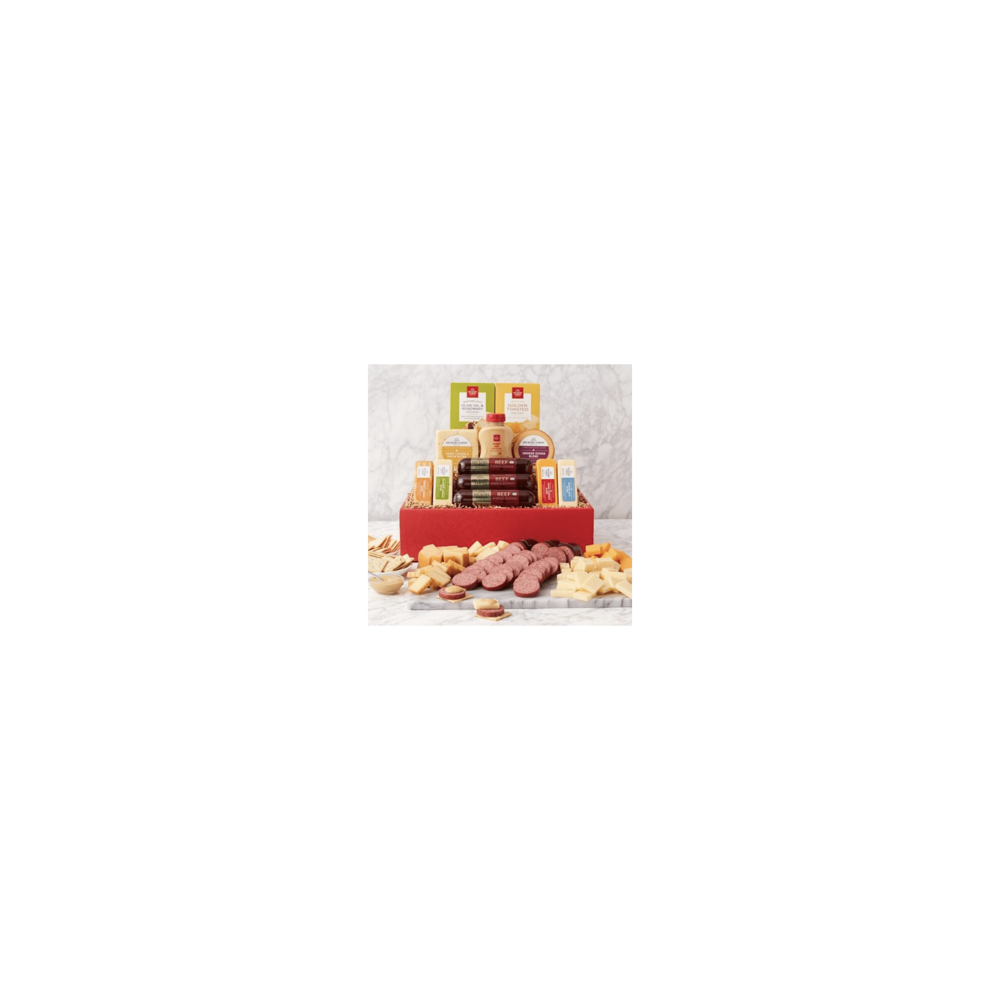 A gourmet gift basket features artfully arranged cheeses, meats, and snacks.