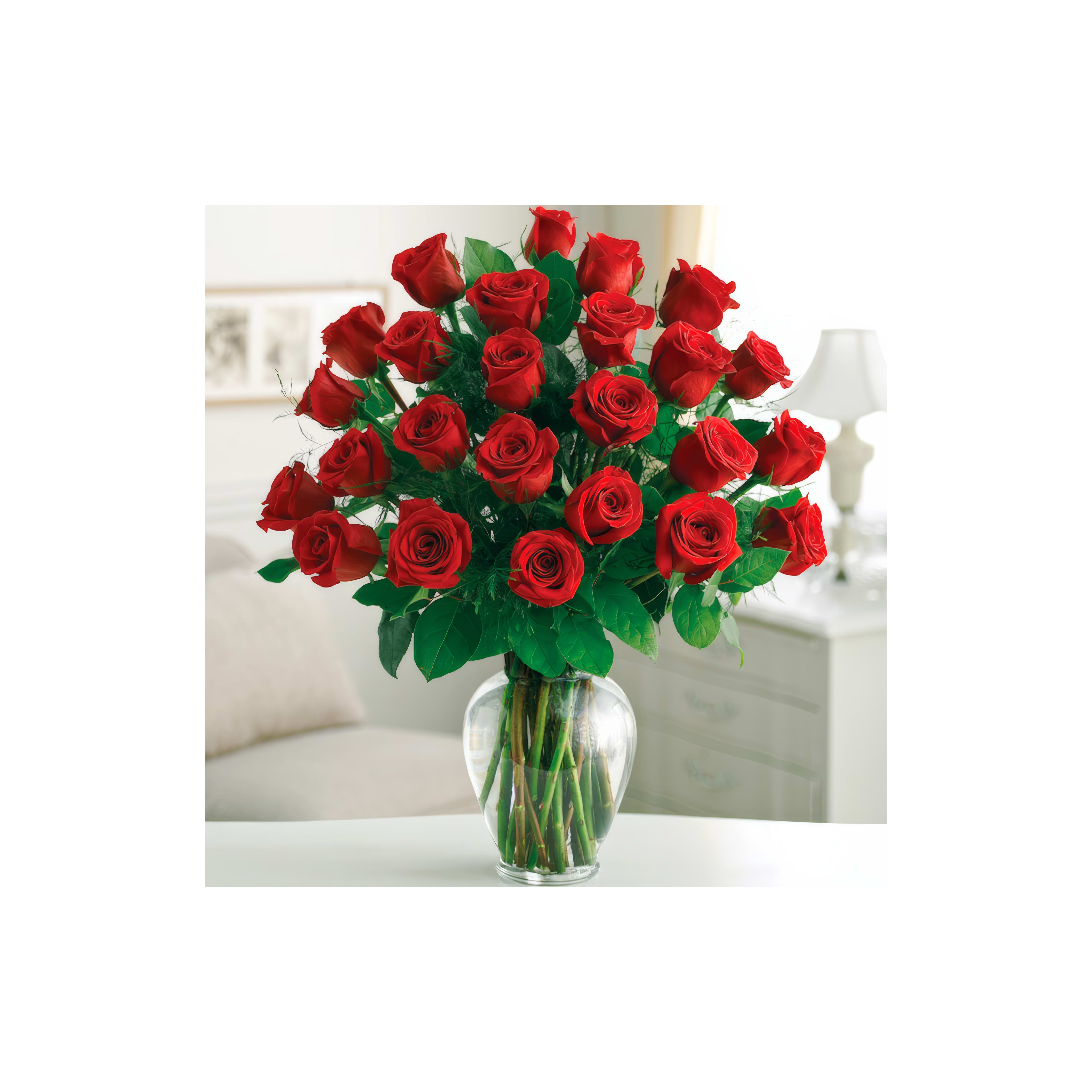 A stunning arrangement of red roses fills a glass vase, brightening the room with their beauty.