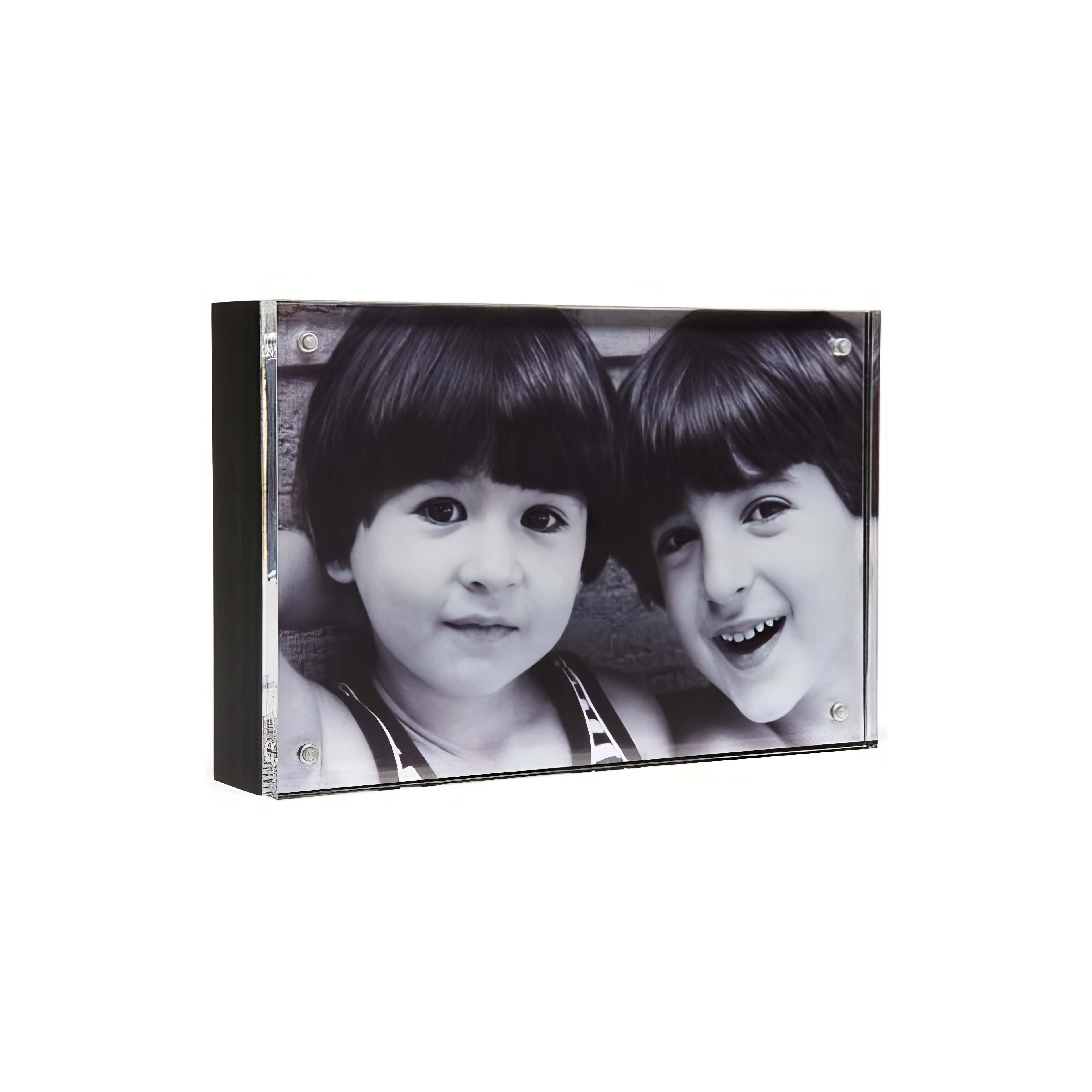 Two boys share smiles while enjoying the warmth of a sunny day outdoors.