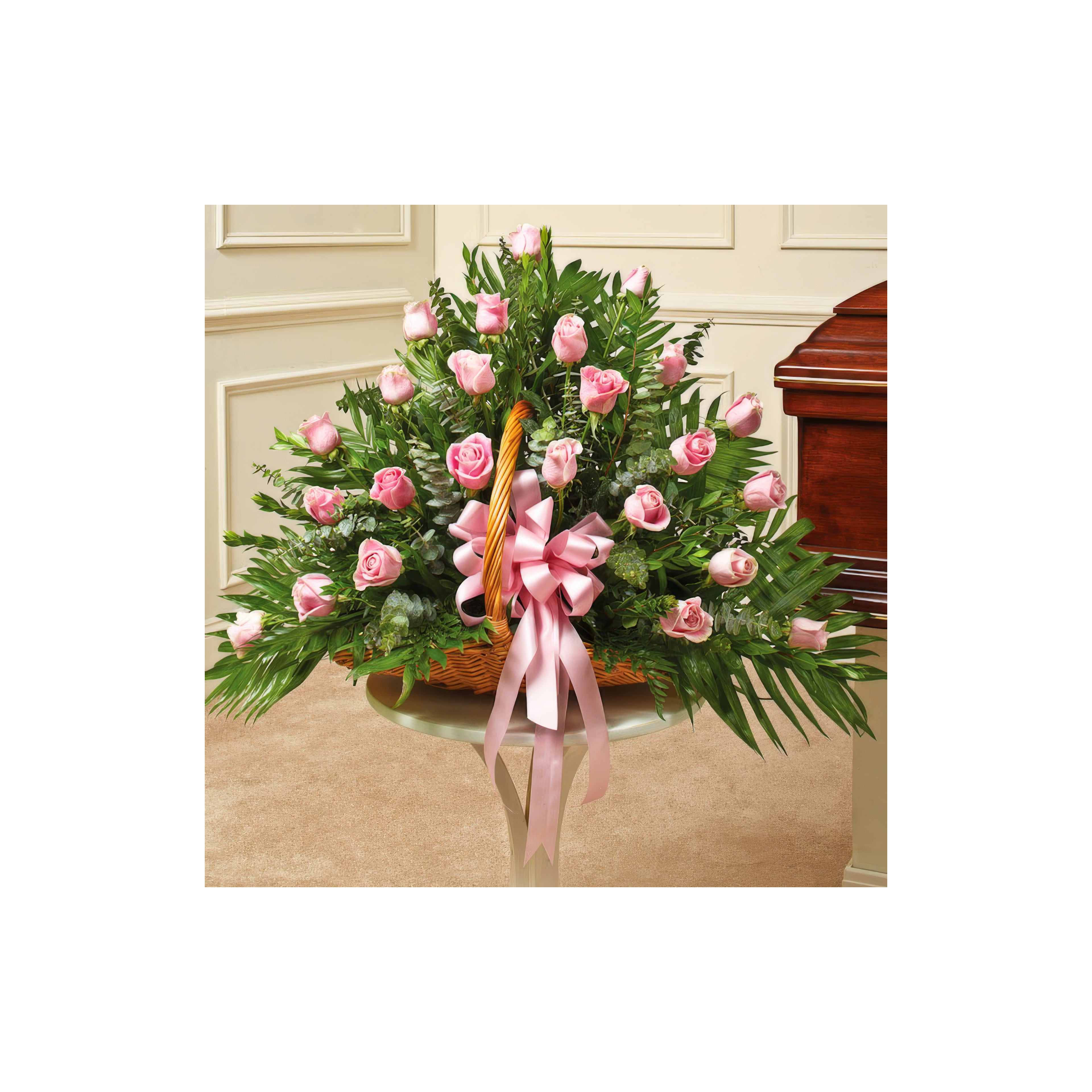 Pink roses and greenery in a basket, perfect for celebrations.