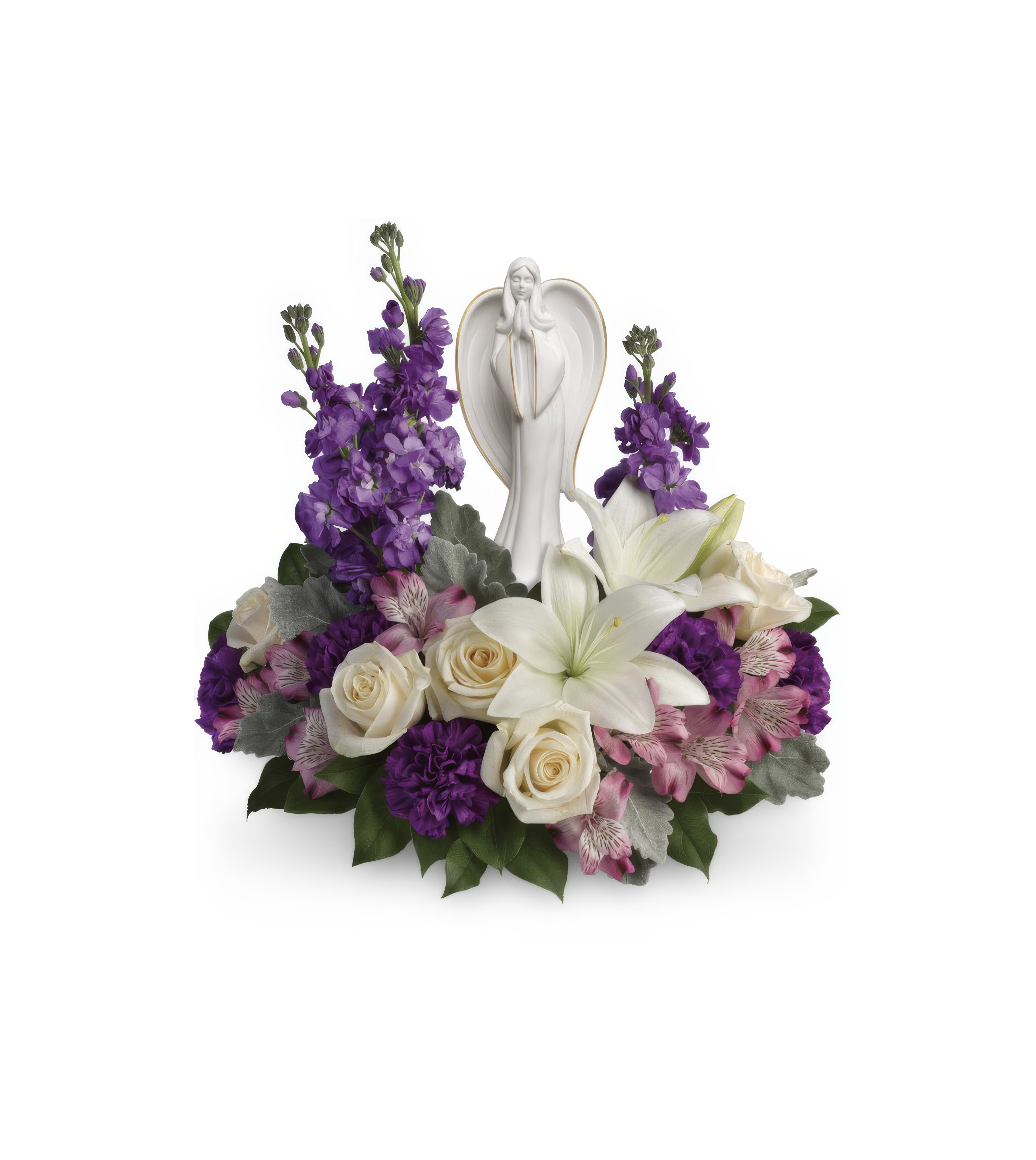 Elegant floral arrangement with white lilies, purple flowers, and a central angel figurine.