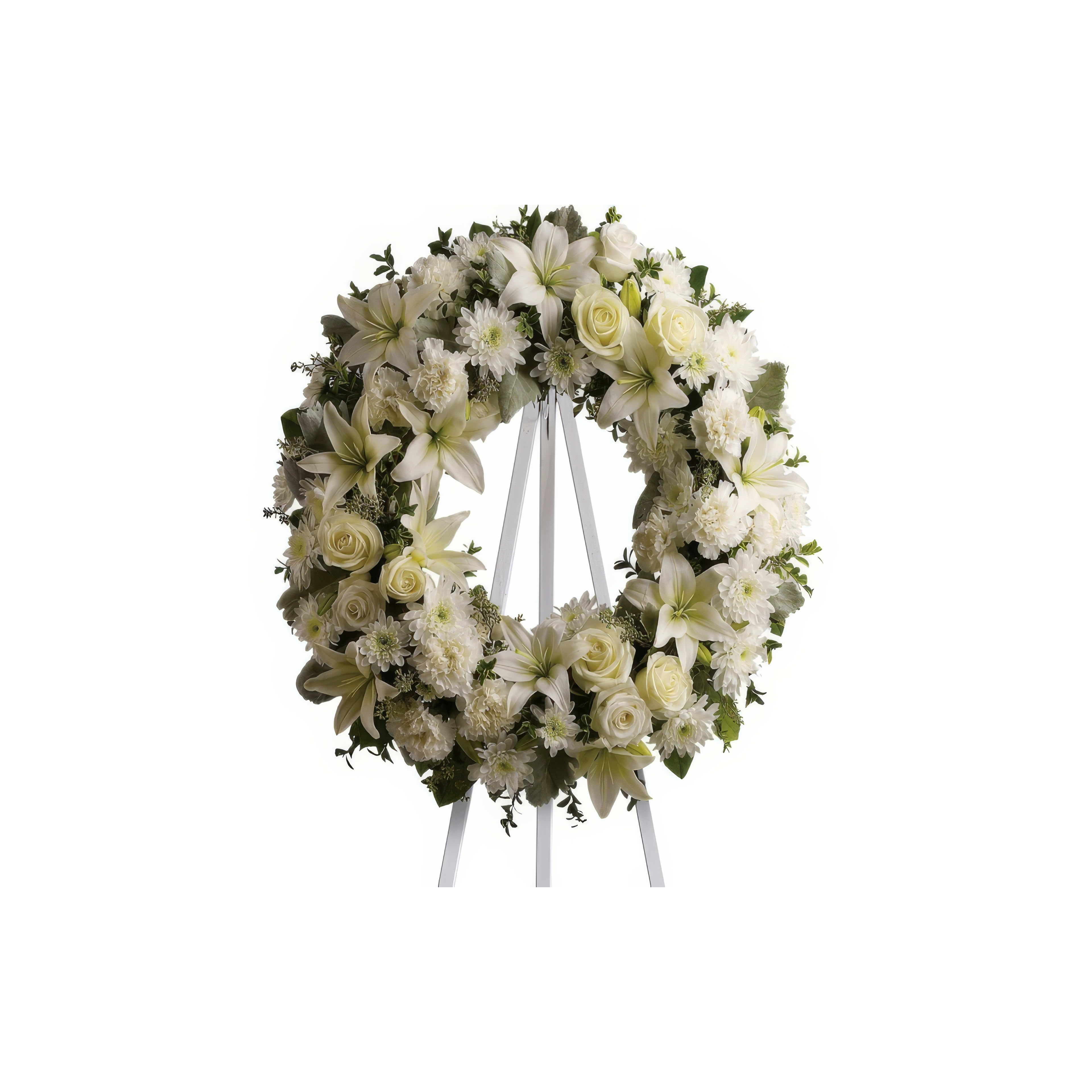 A beautiful white floral wreath stands on a tripod, symbolizing remembrance and honor.