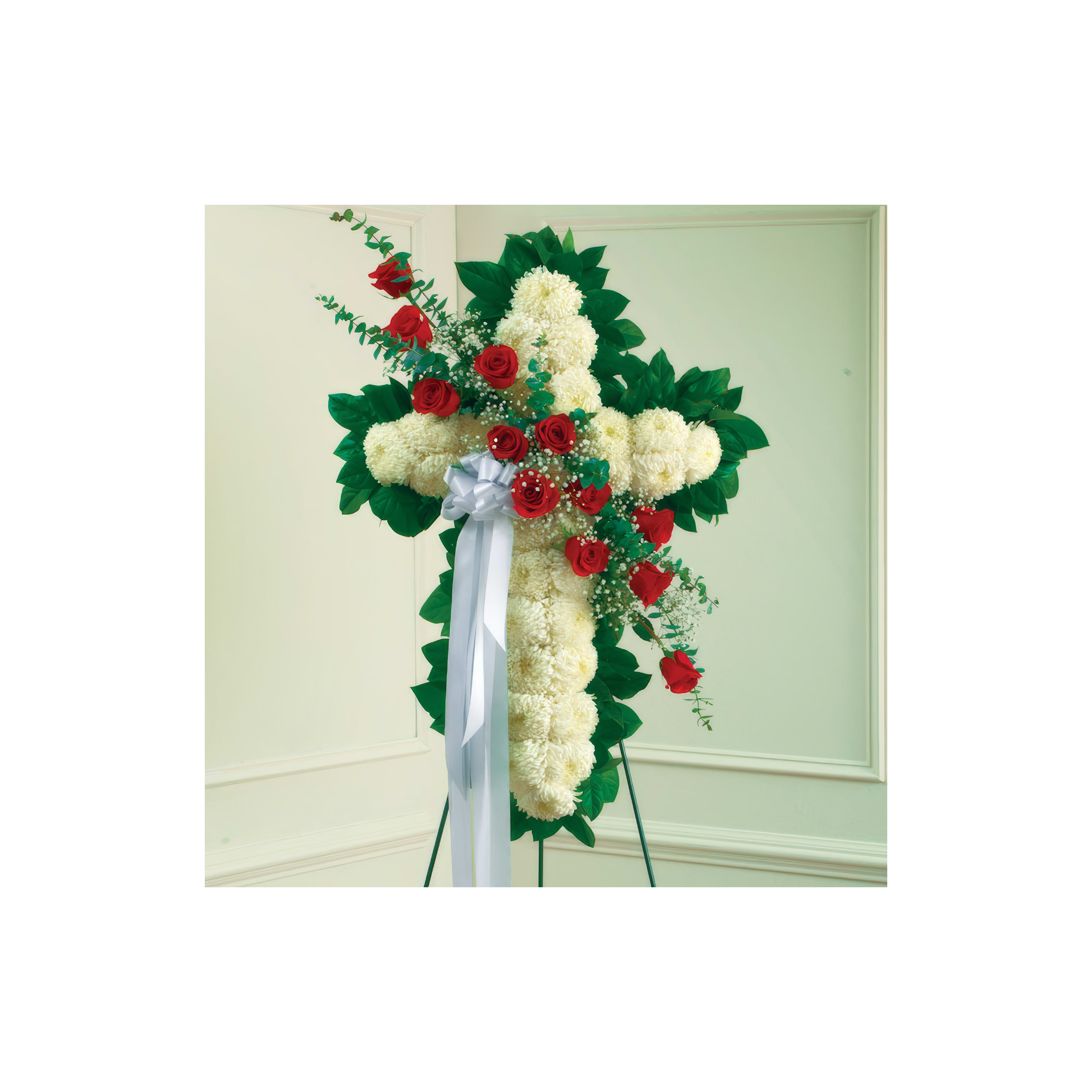 Beautiful floral cross arrangement featuring white and red flowers, perfect for a memorial service.