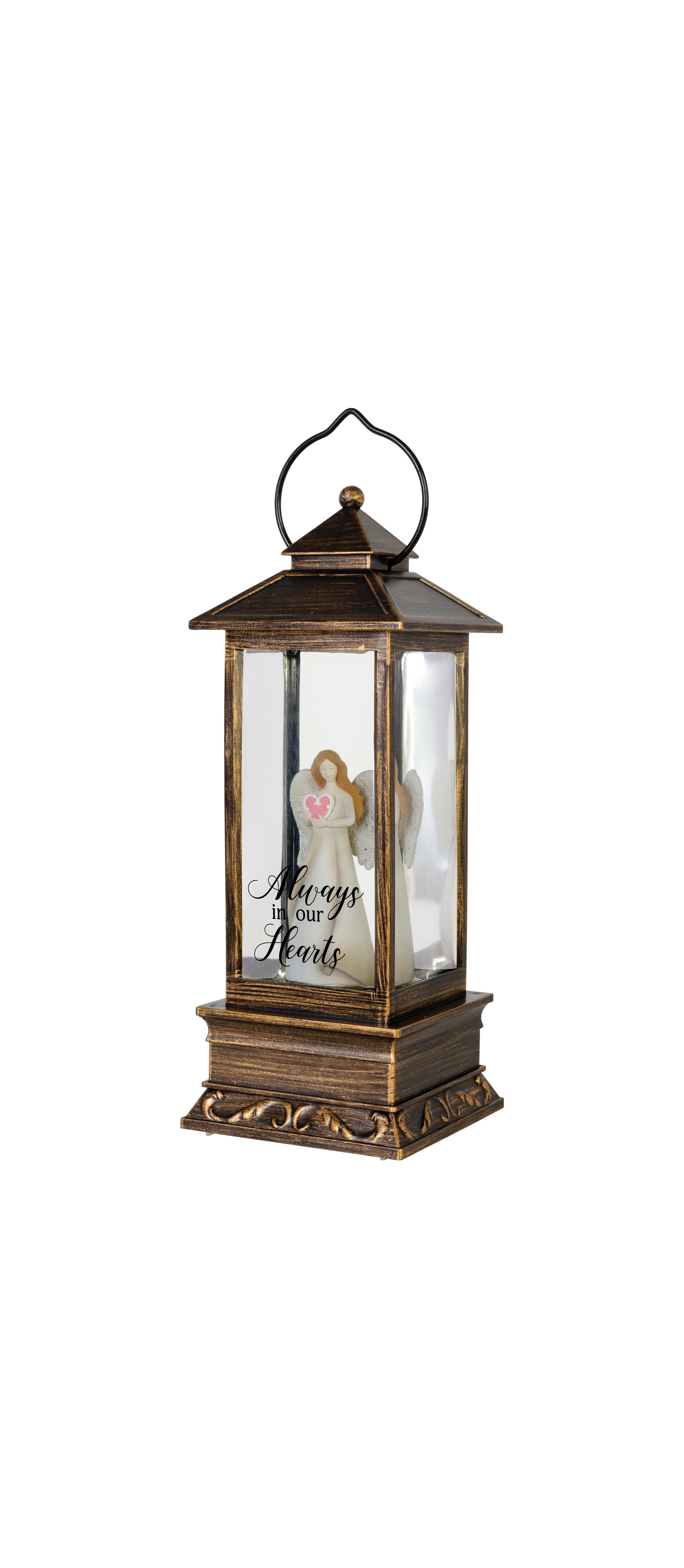 Elegant lantern displays angel figurine holding a heart, symbolizing remembrance and love.