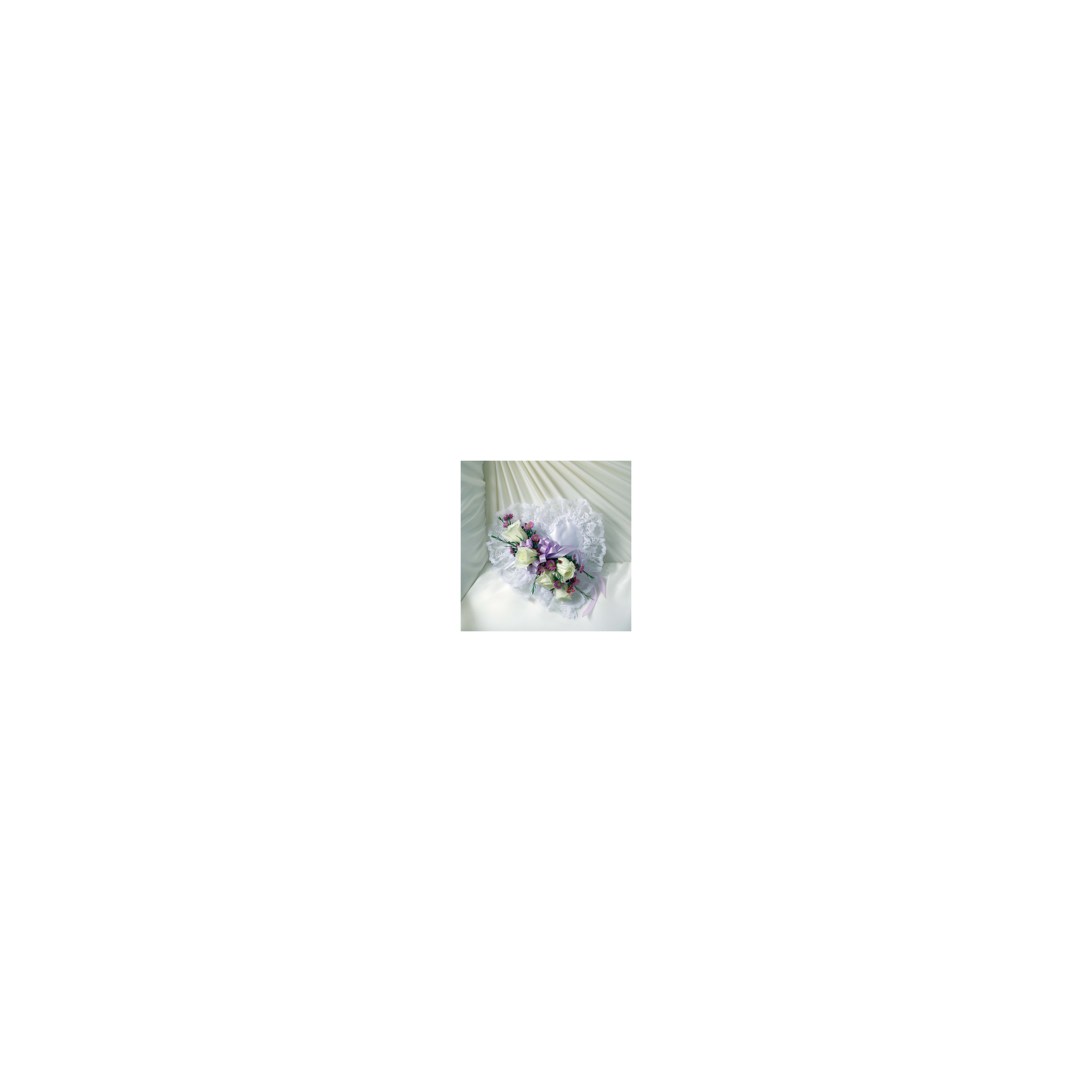 A lovely mix of white roses and purple flowers on soft, white, draped fabric.