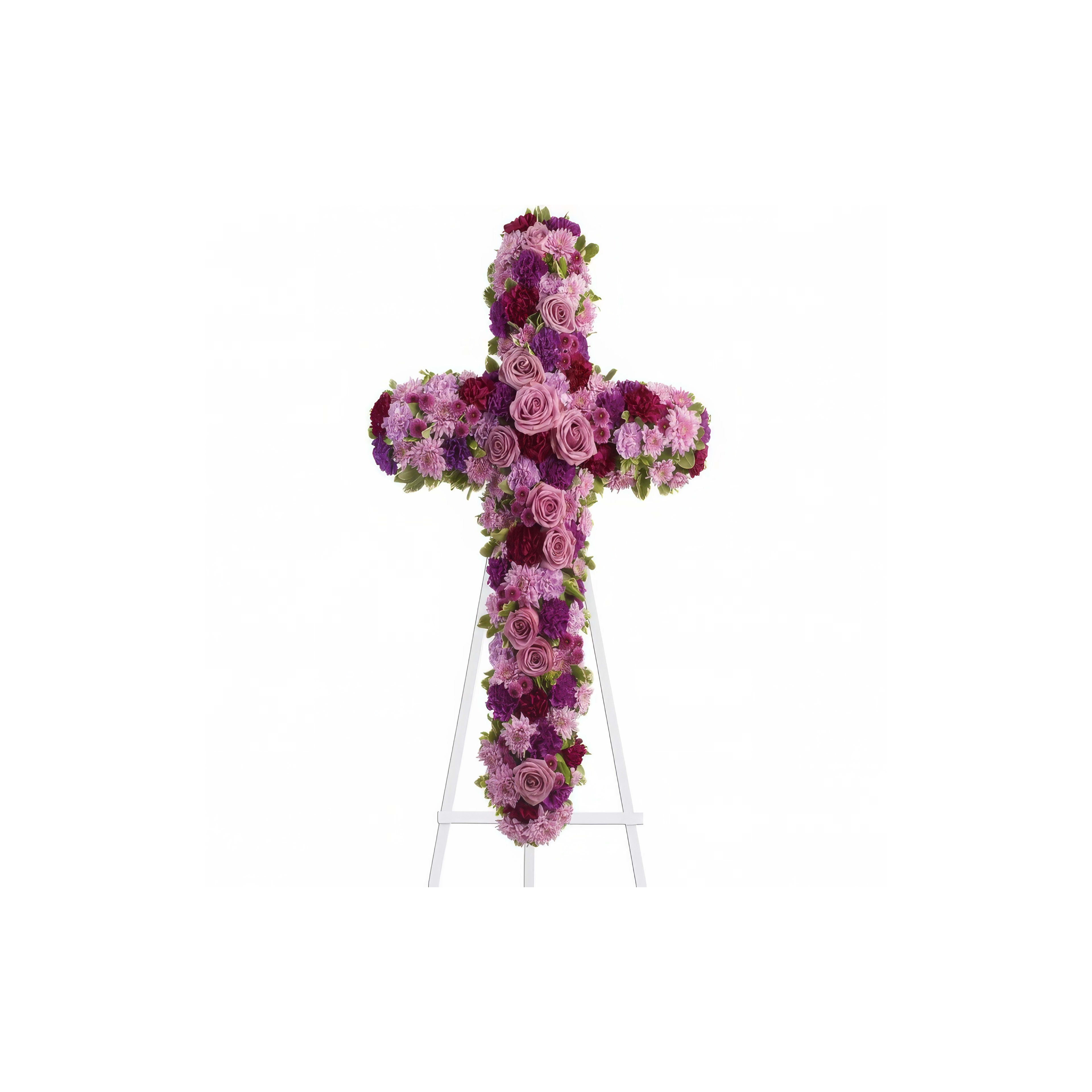 A beautiful floral cross made of roses and other blooms is shown on an easel at a memorial.