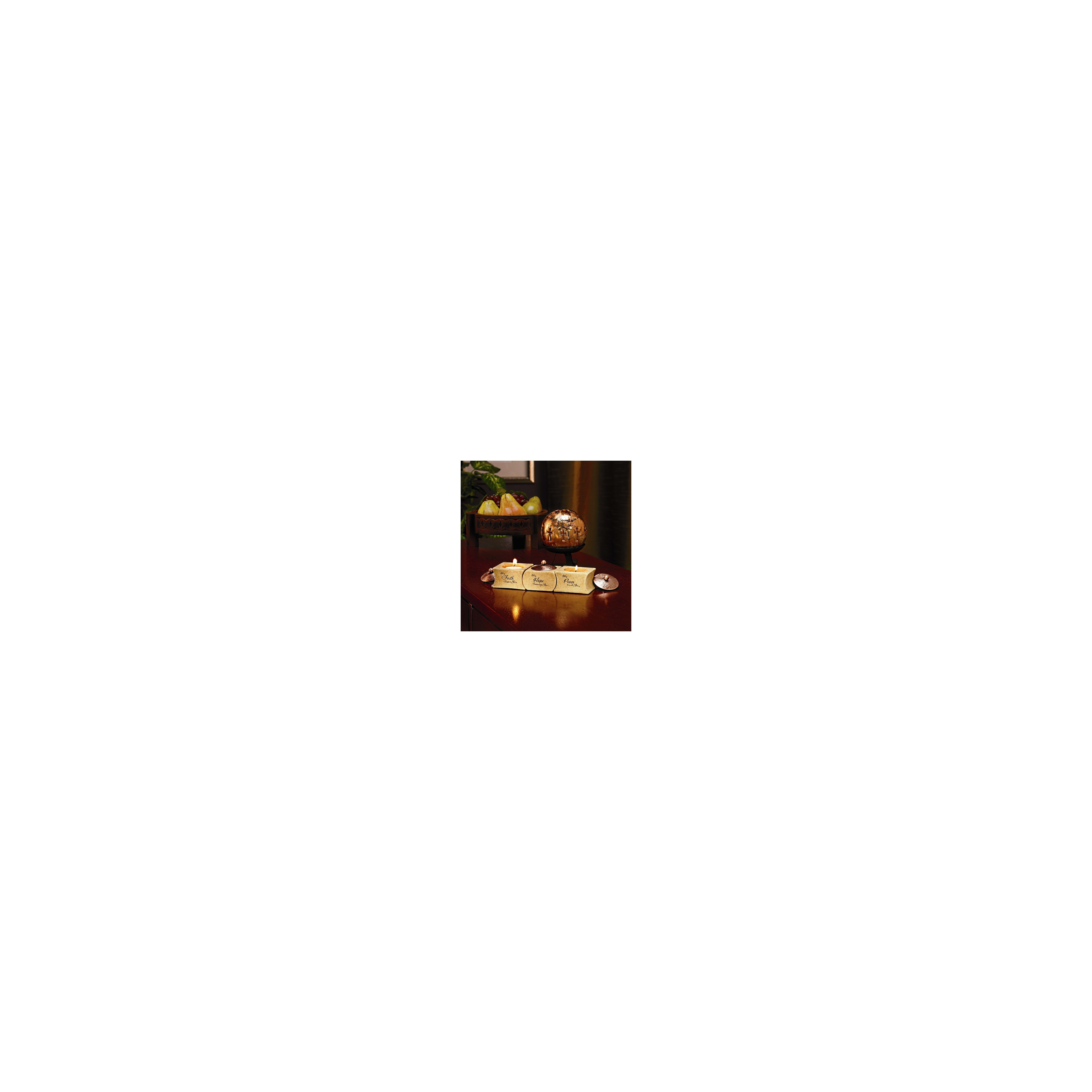 Three lit decorative candles sit on a polished wooden table next to a bowl of fresh fruit.