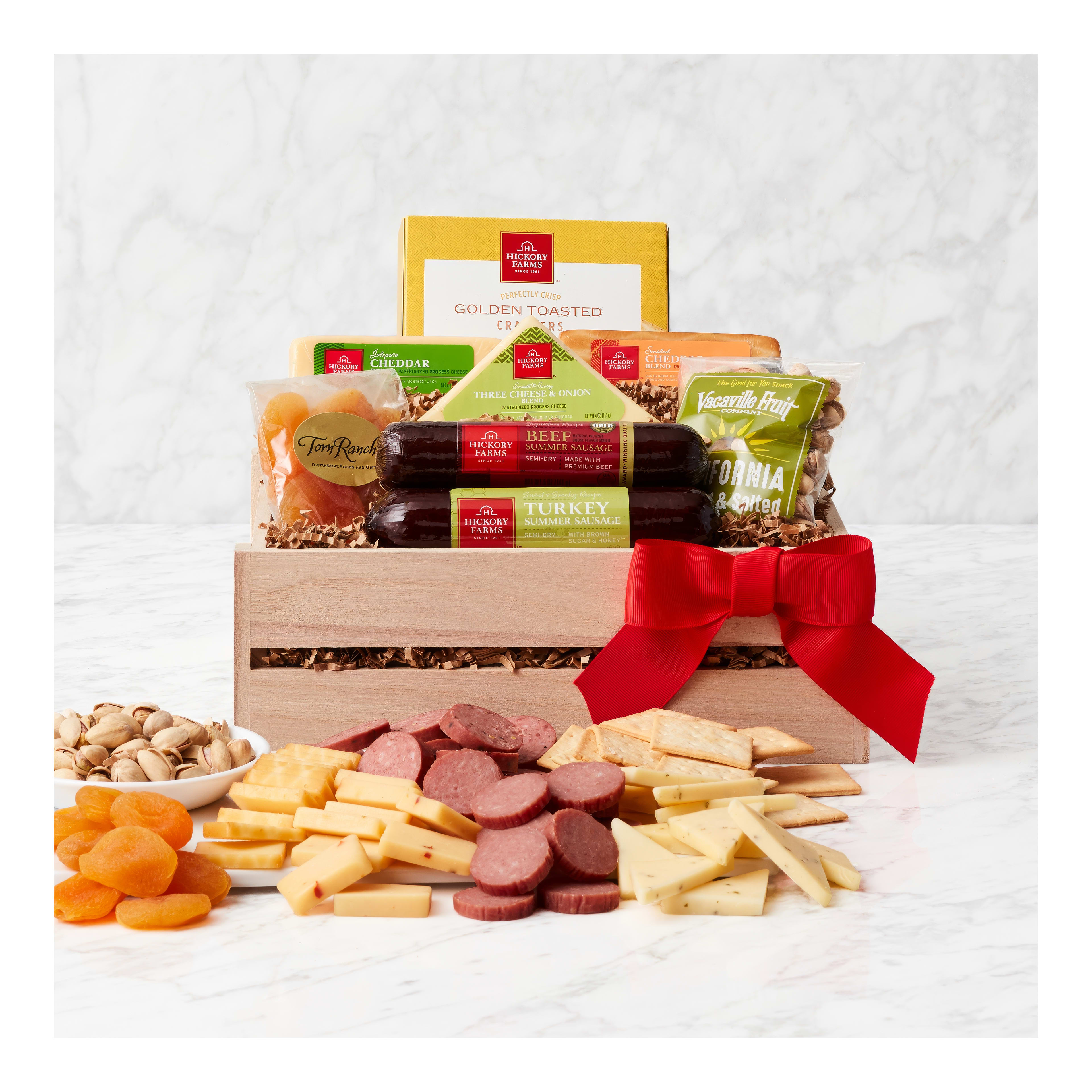 A lovely gift basket filled with cheeses, meats, and dried fruits, ideal for sharing.