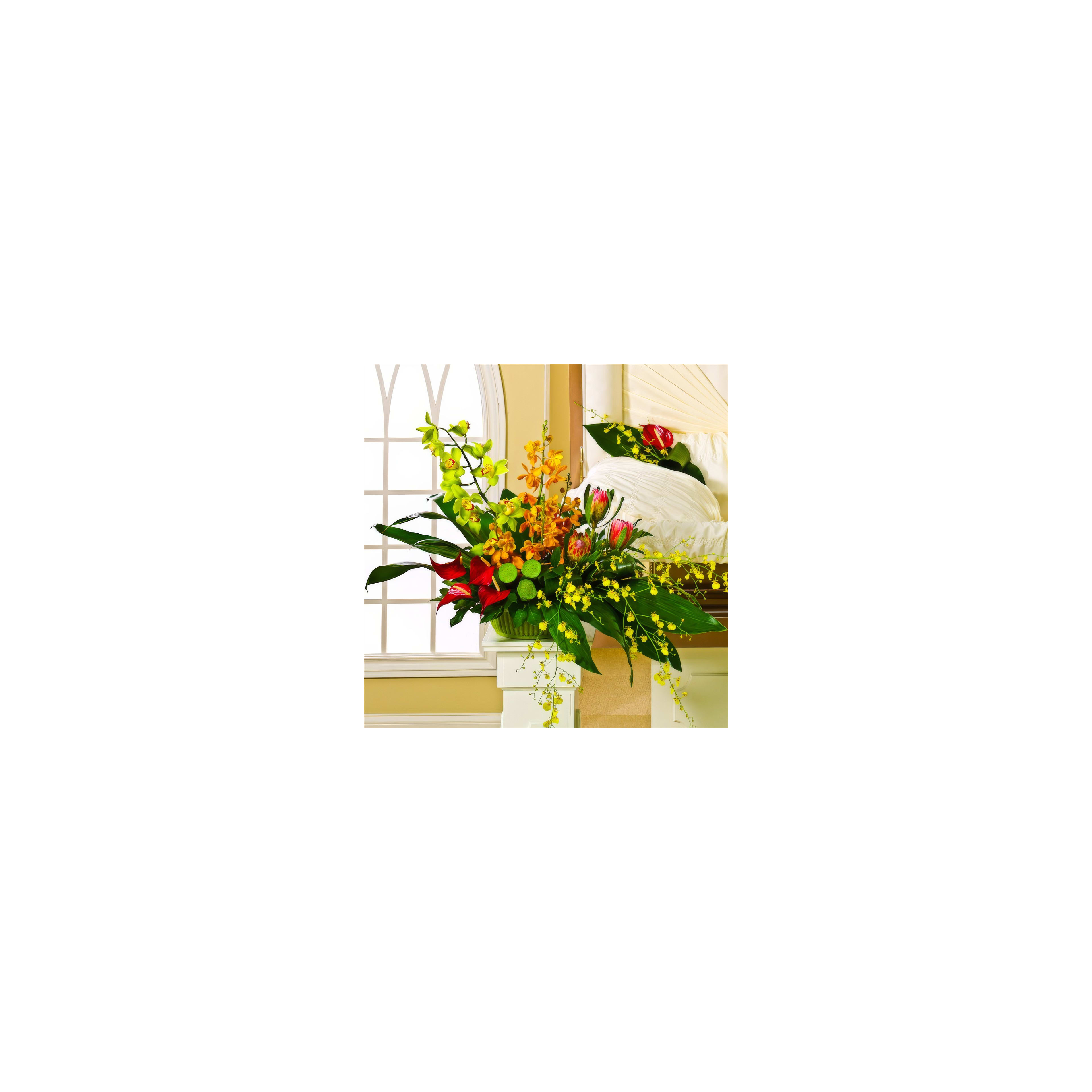 A colorful floral display features bright flowers and greens in a cozy room with natural light.