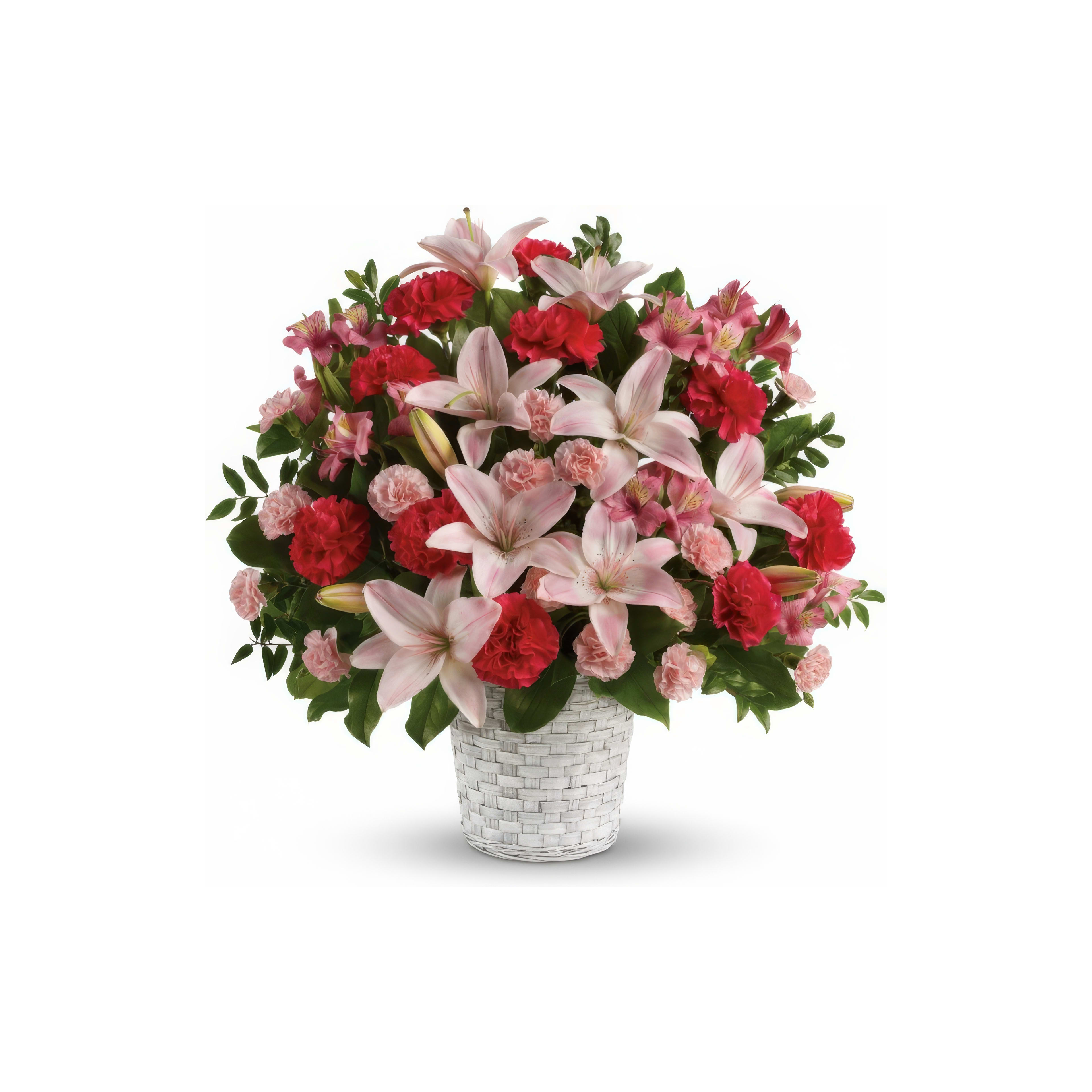 A woven basket overflows with vibrant pink lilies and red carnations.