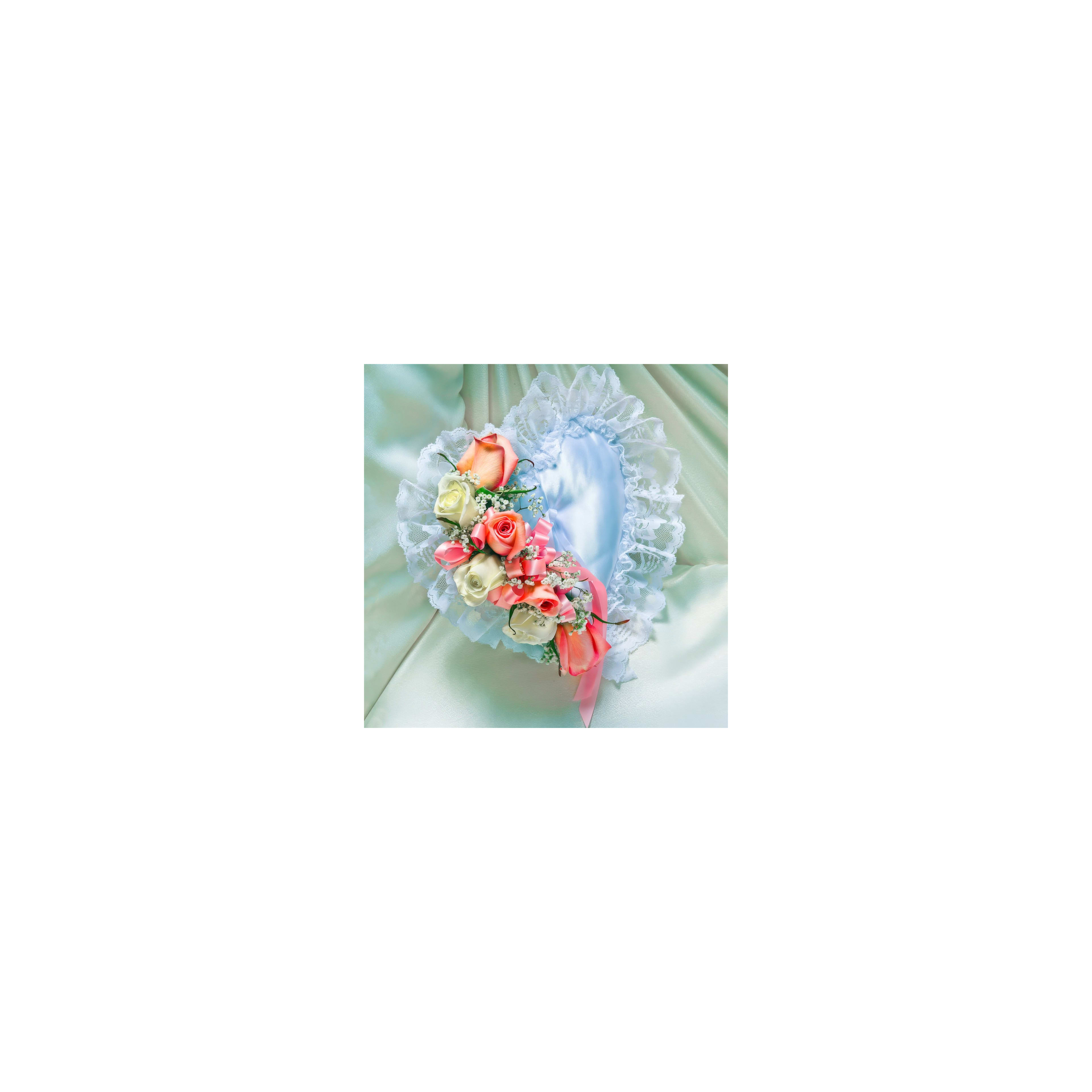Heart-shaped decoration features pastel roses and lace, perfect for romance or celebration.