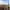 Panorama over Manchester sentrum med tettpakkede kontorbygg, det gotiske rådhustårnet i midten og høyhusene City Tower og Beetham Tower som rager over byen under en blå himmel.