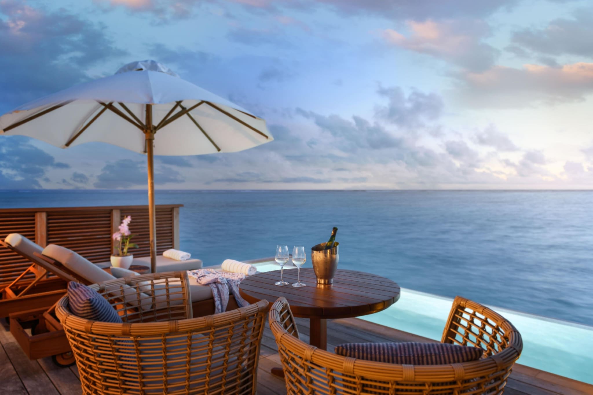 Champagne on ice on a terrace above the sea at sunset at Conrad Maldives Rangali Island.