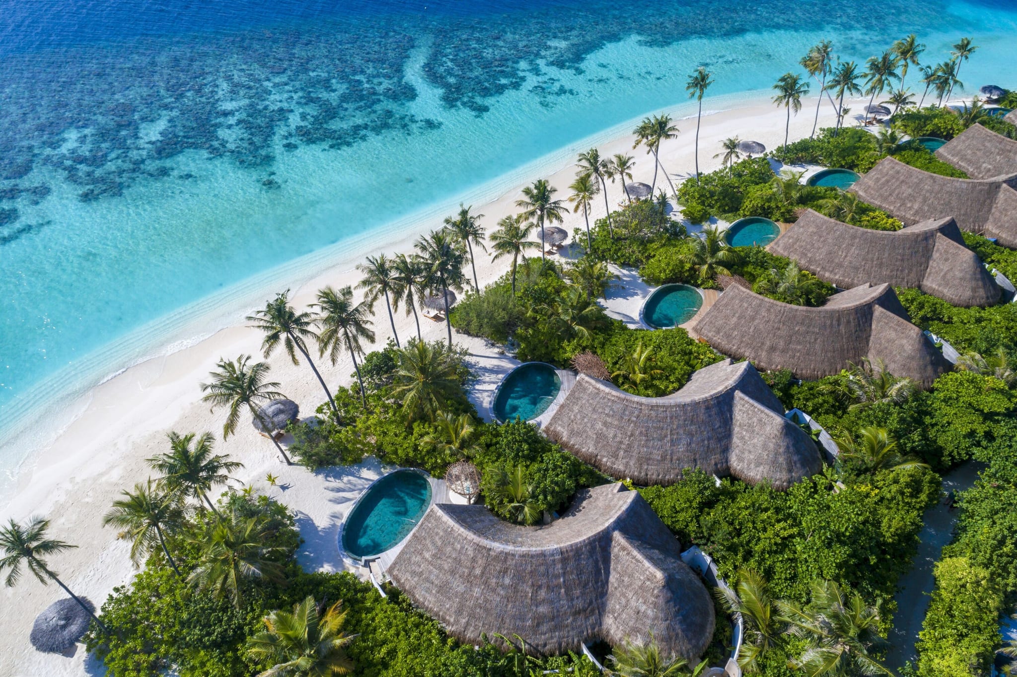 Aerial view of beach villas with pools and white sand at Milaidhoo in Baa Atoll.