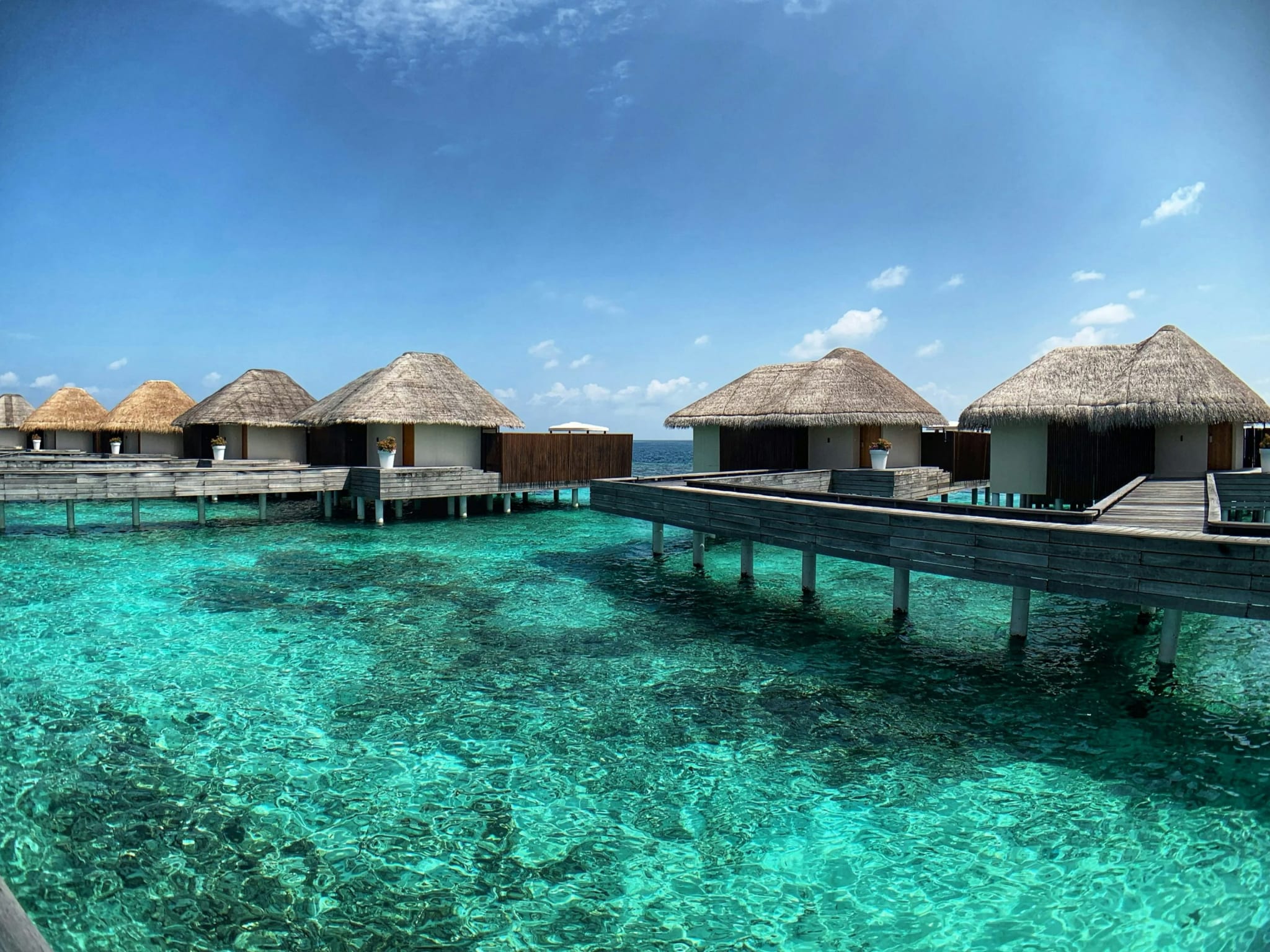 Water villas on stilts over a turquoise lagoon in the Maldives