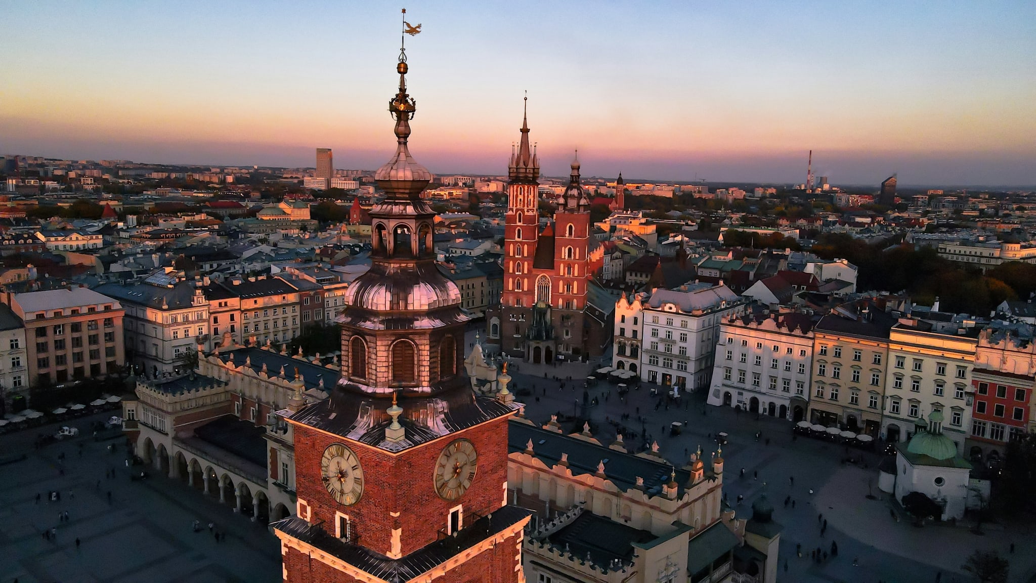 Rooftops and church spires in Kraków old town at sunset
