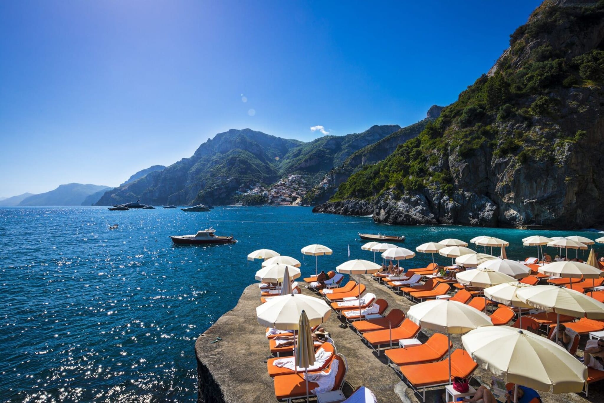 Sun loungers at Il San Pietro with Positano in the background