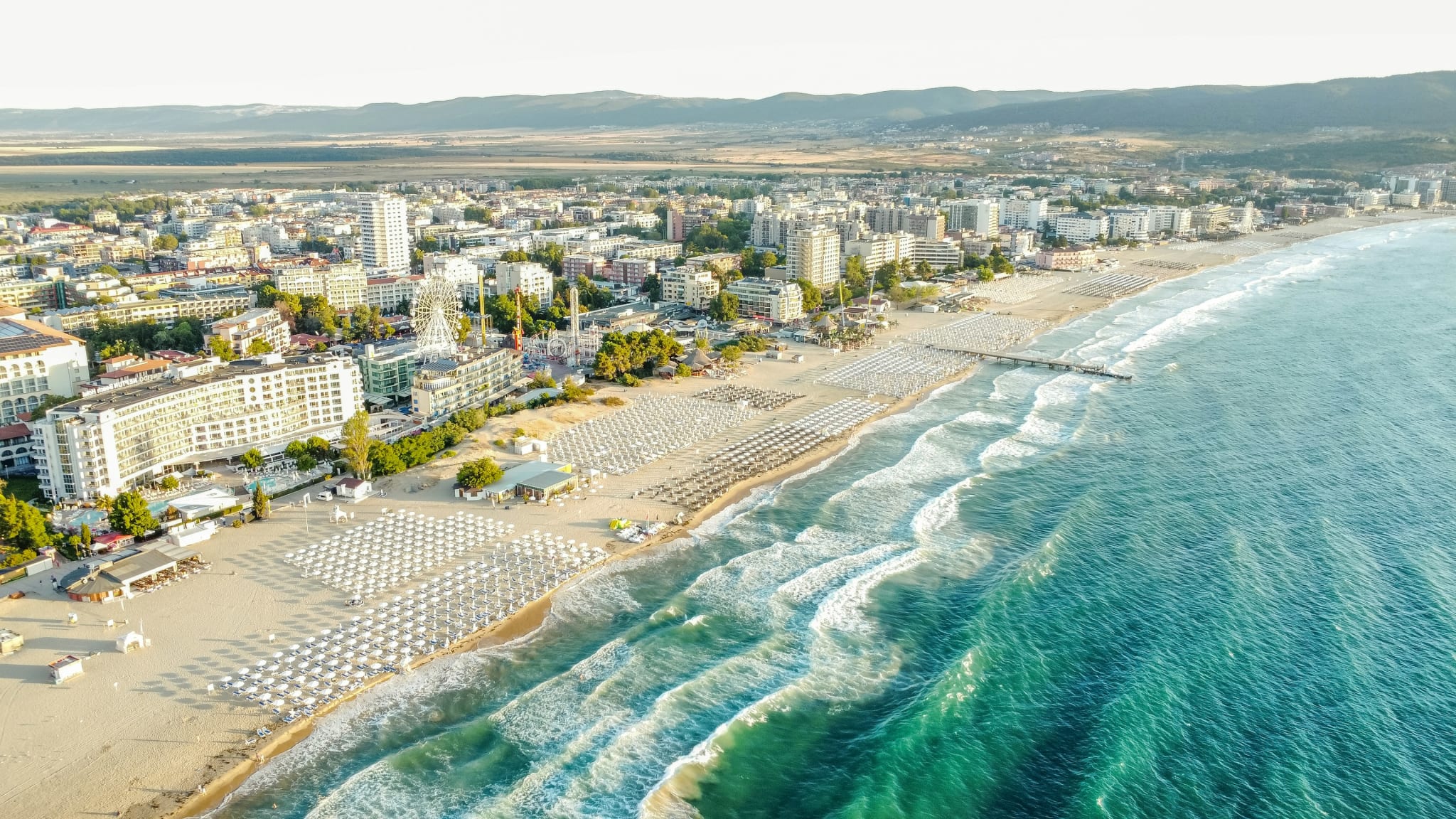 Sunny Beach in Bulgaria seen from above, with the long sandy beach, turquoise sea and hotels along the shore