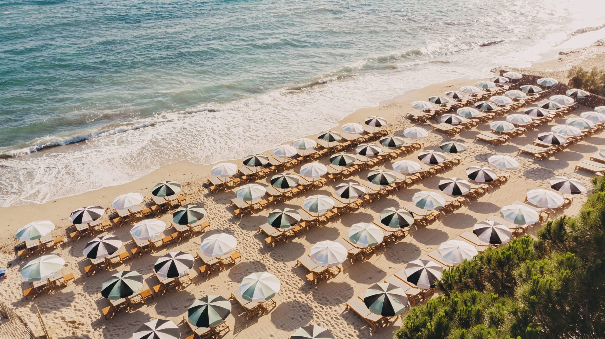 Beach with sunbeds and parasols at Lily of the Valley in La Croix-Valmer near Saint-Tropez