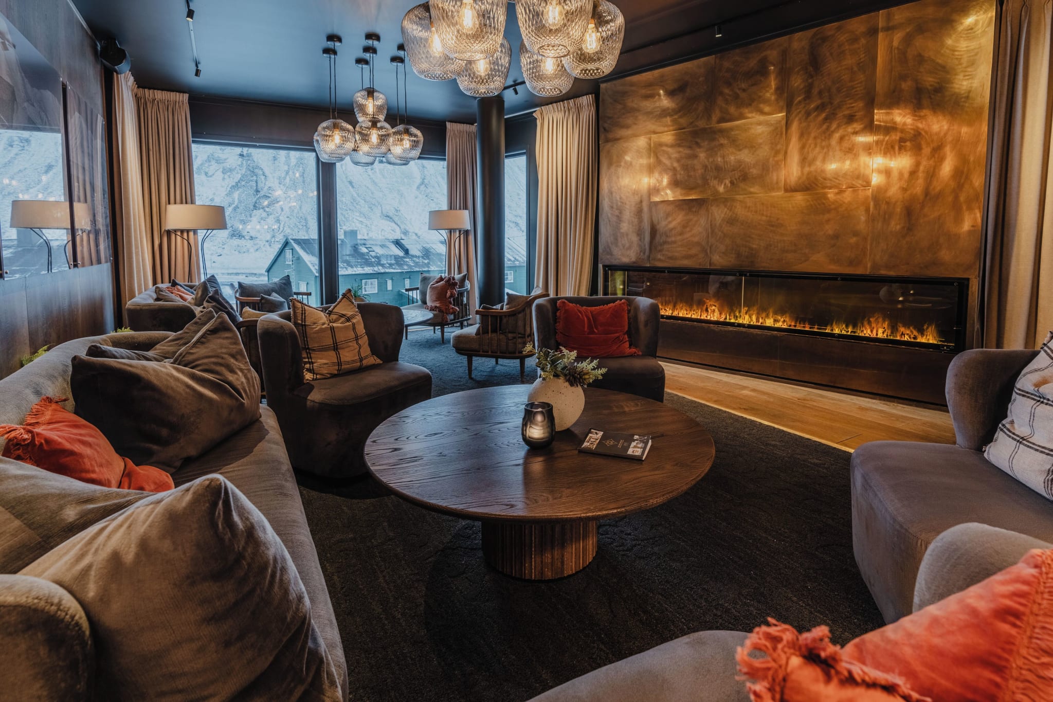 Fireside lounge with furs and wood at Funken Lodge in Svalbard