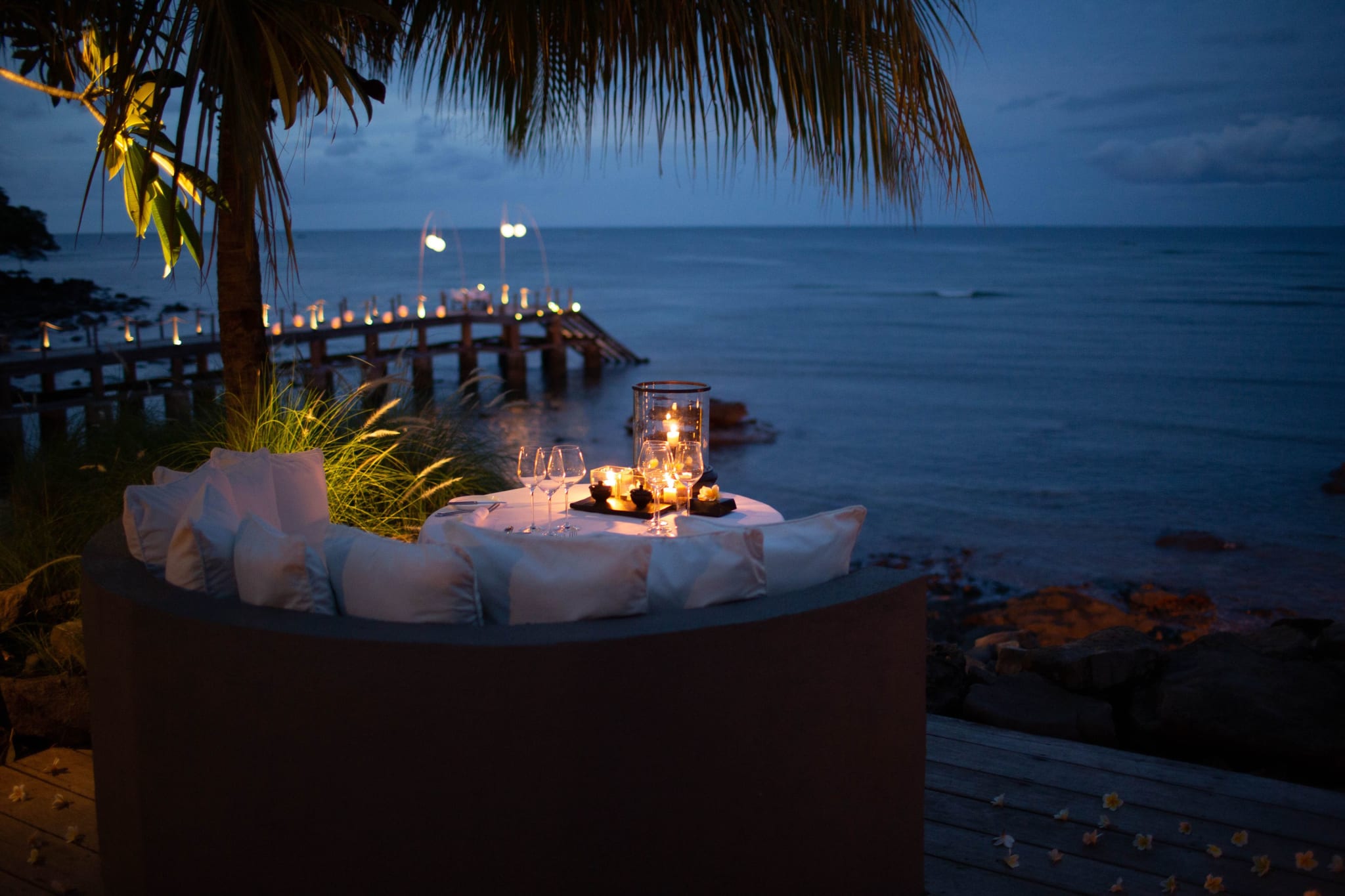 Dinner table on the jetty at dusk at The Lombok Lodge