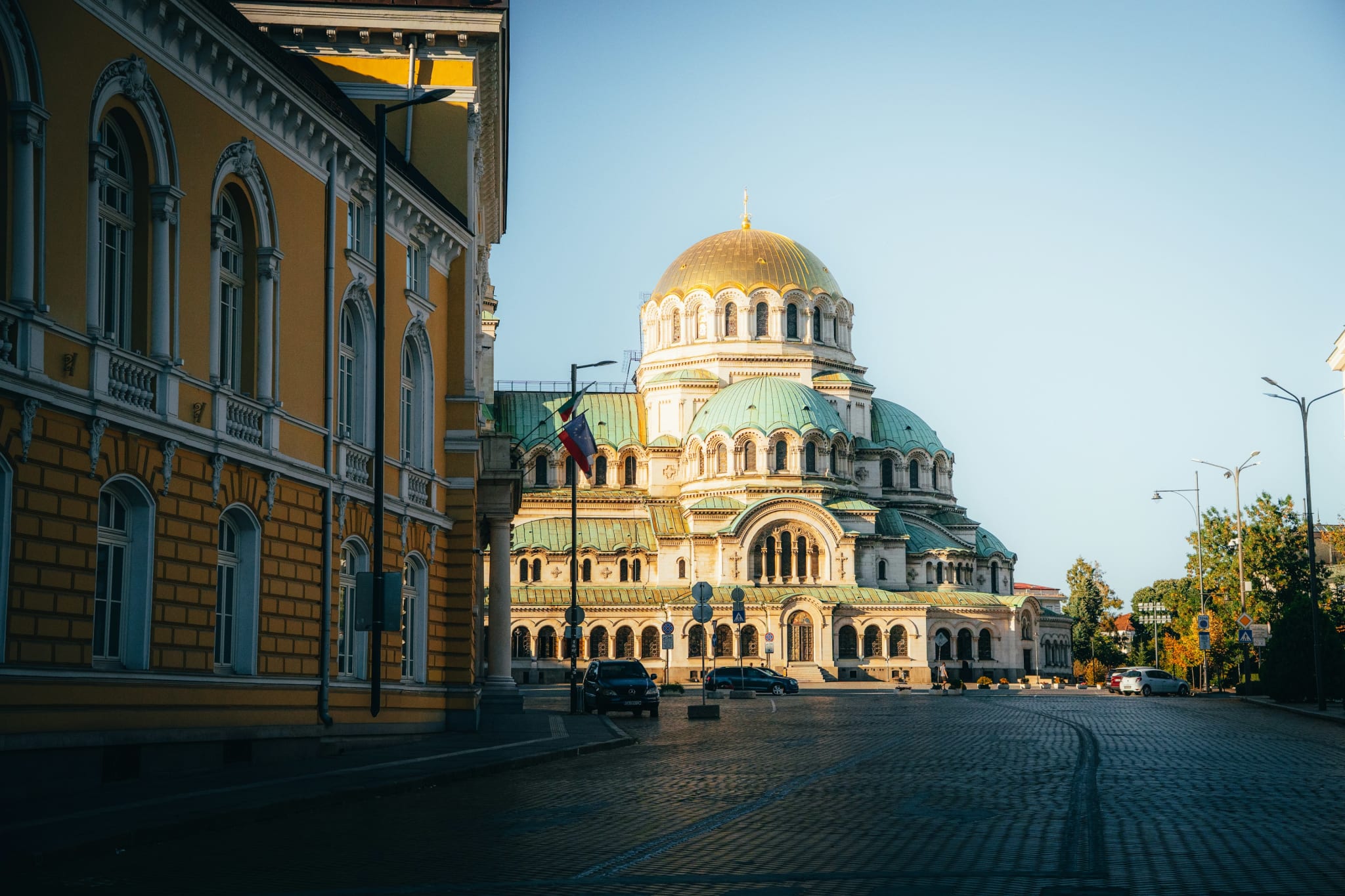 Alexander Nevsky Cathedral in Sofia in golden evening light, seen from a cobbled street