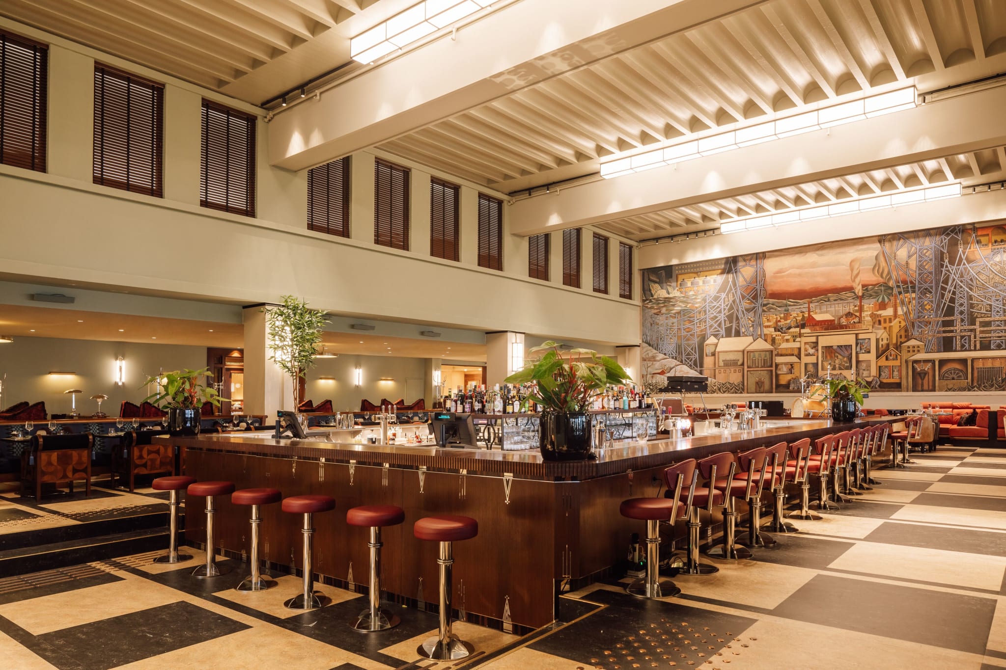 The Ekspedisjonshallen at Sommerro, with its high ceiling and Per Krohg's mural behind the bar