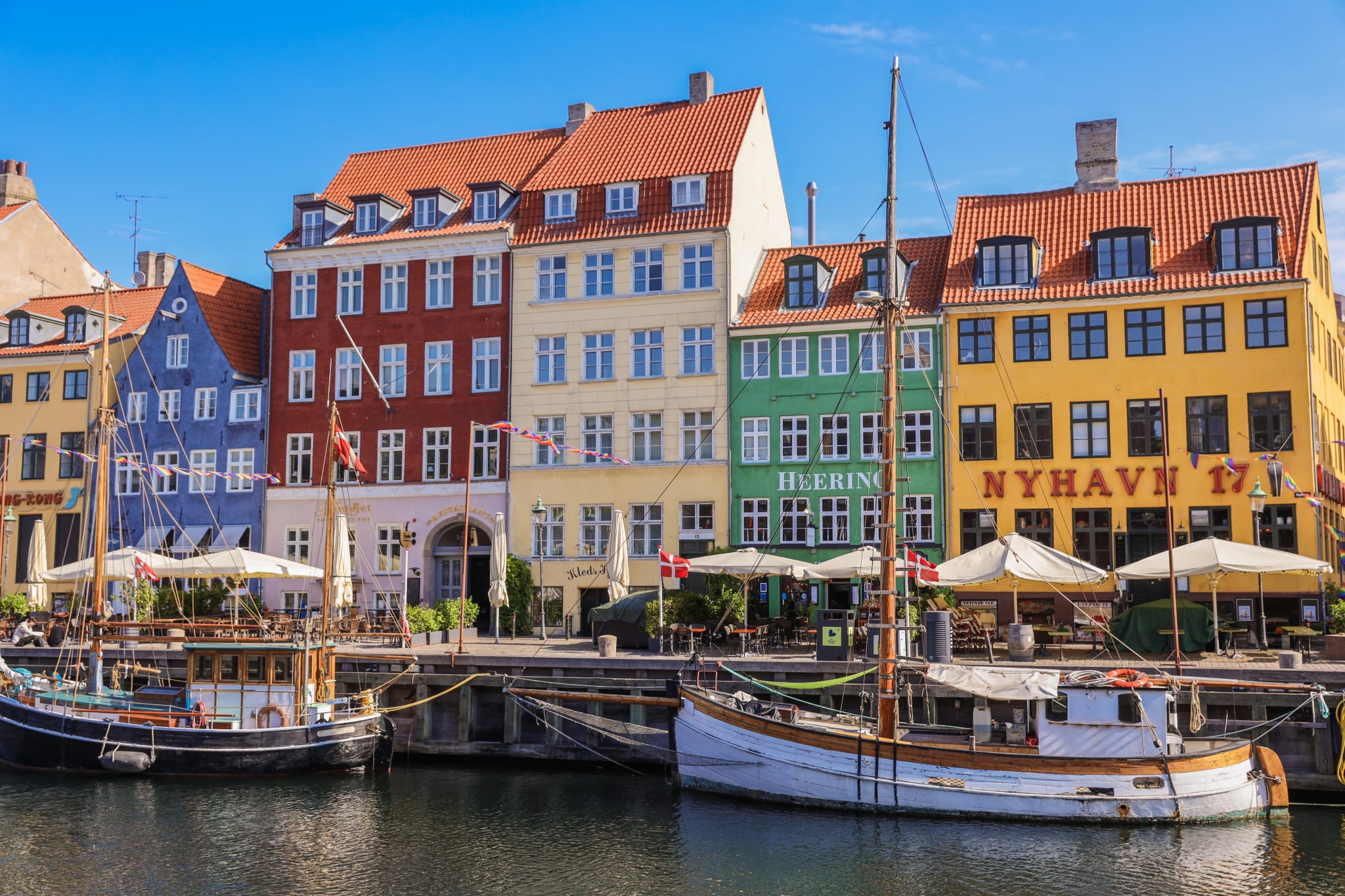 Colourful facades and old sailing boats along the canal in Nyhavn, Copenhagen