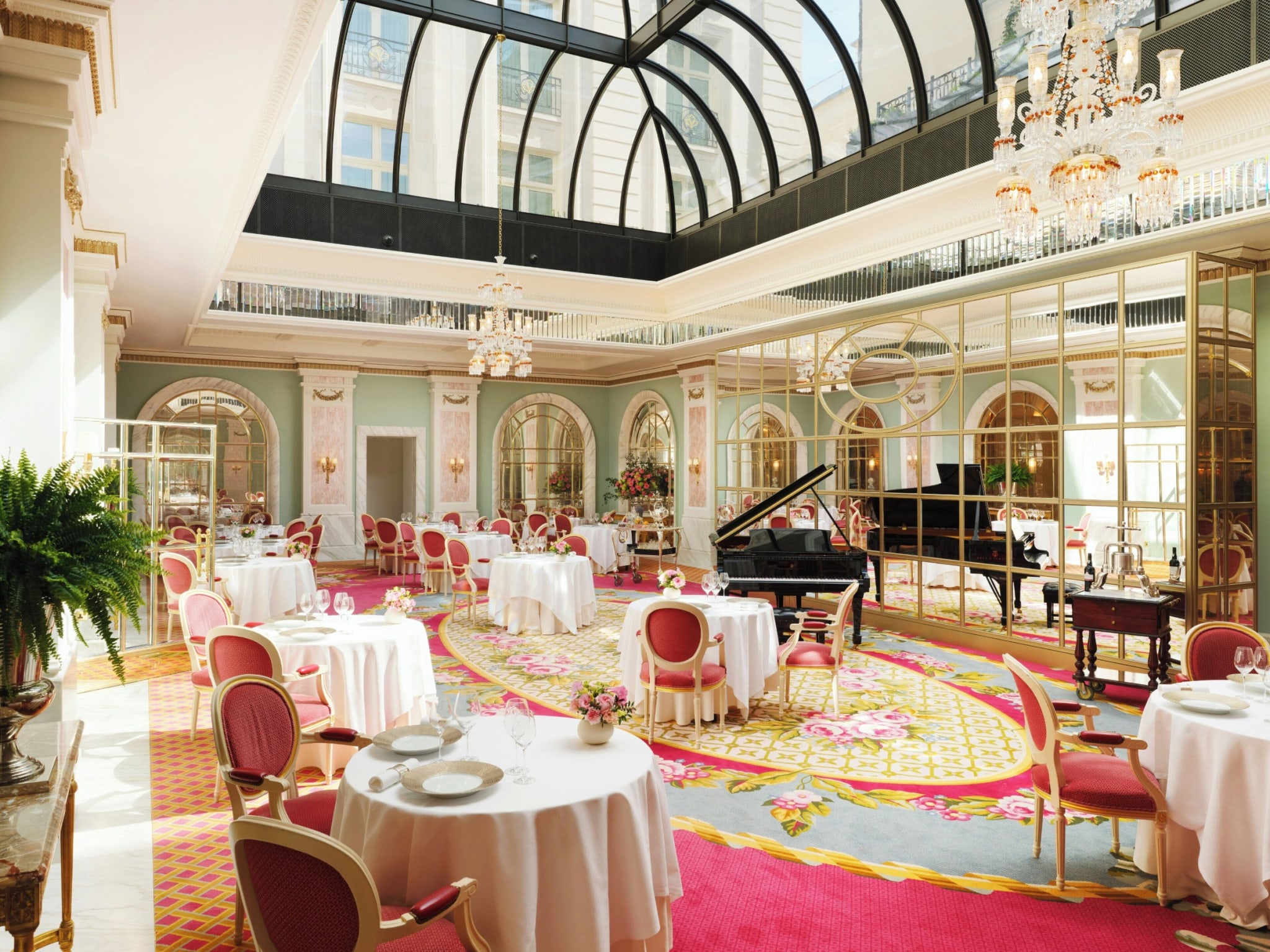 Gilded salon with laid tea tables beneath the skylight in the Palm Court at The Ritz London
