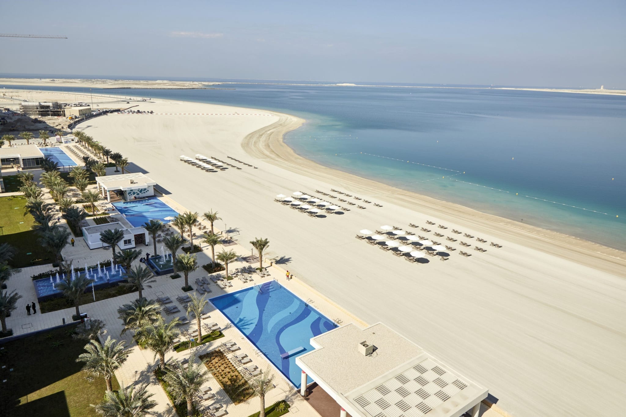 The beach and pool at Riu Dubai Beach Resort from the air