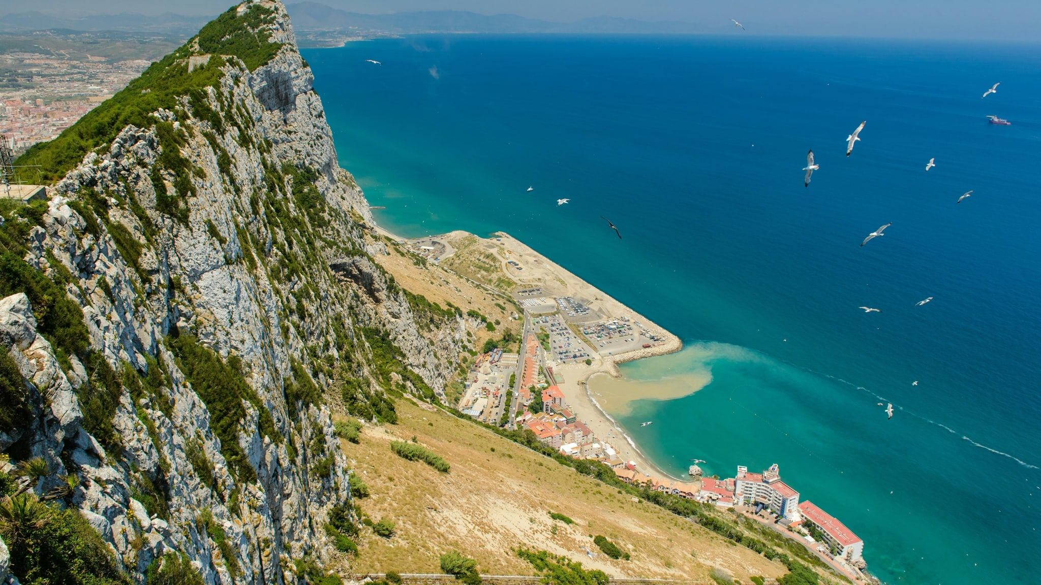 The cliffs of the Rock of Gibraltar seen from above with the sea below