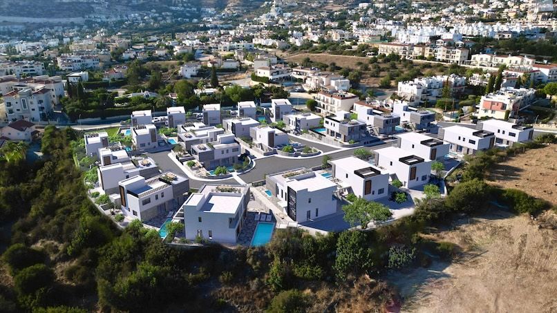 Aerial photograph of the Sentiero Luxury Villas site with digitally rendered villas overlaid, illustrating the full development within its actual landscape.