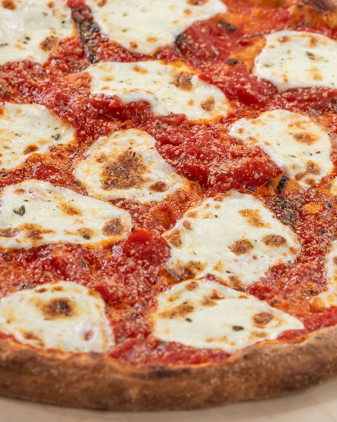 Old Fashioned pizza topped with mozzarella and red sauce