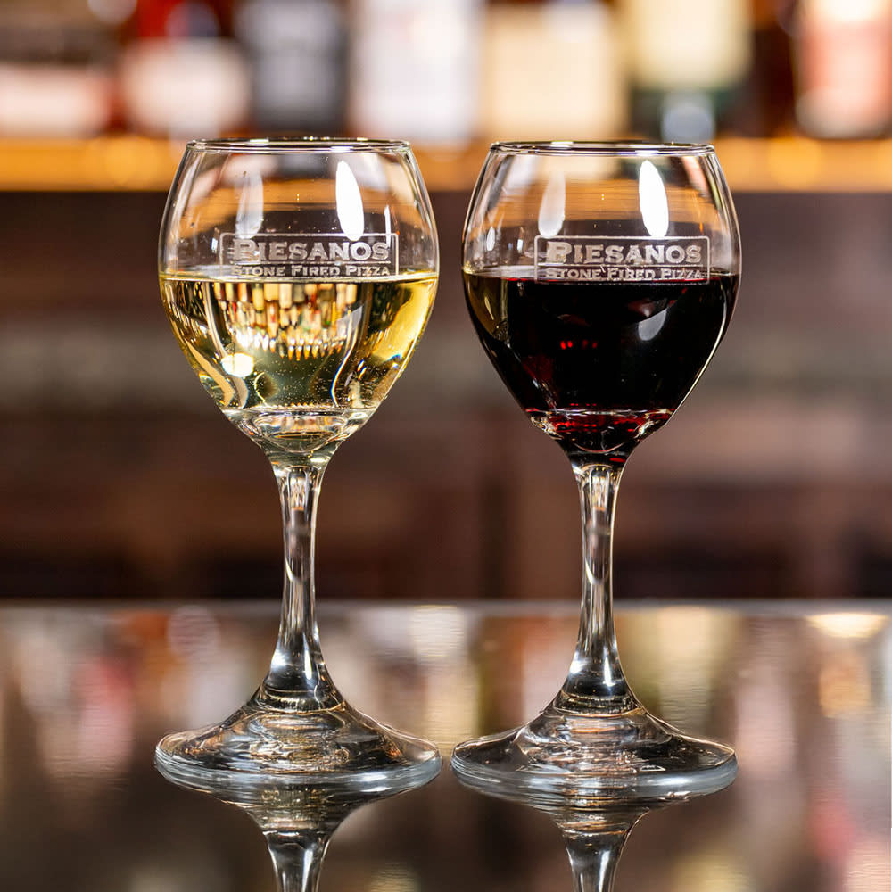 Glasses of white and red wine on a bartop