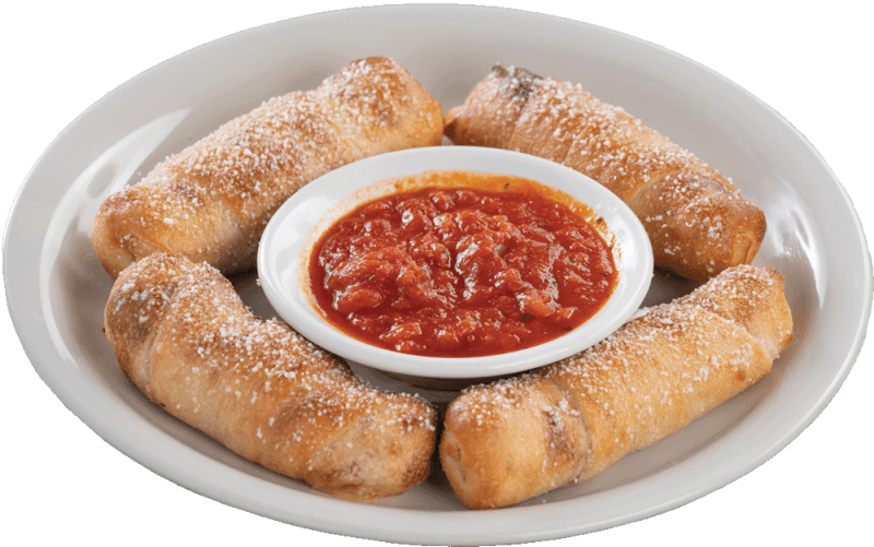 Four pepperoni rolls, sprinkled with cheese are arranged in a circle on a white plate, surrounding a small bowl of chunky red marinara sauce in the center.