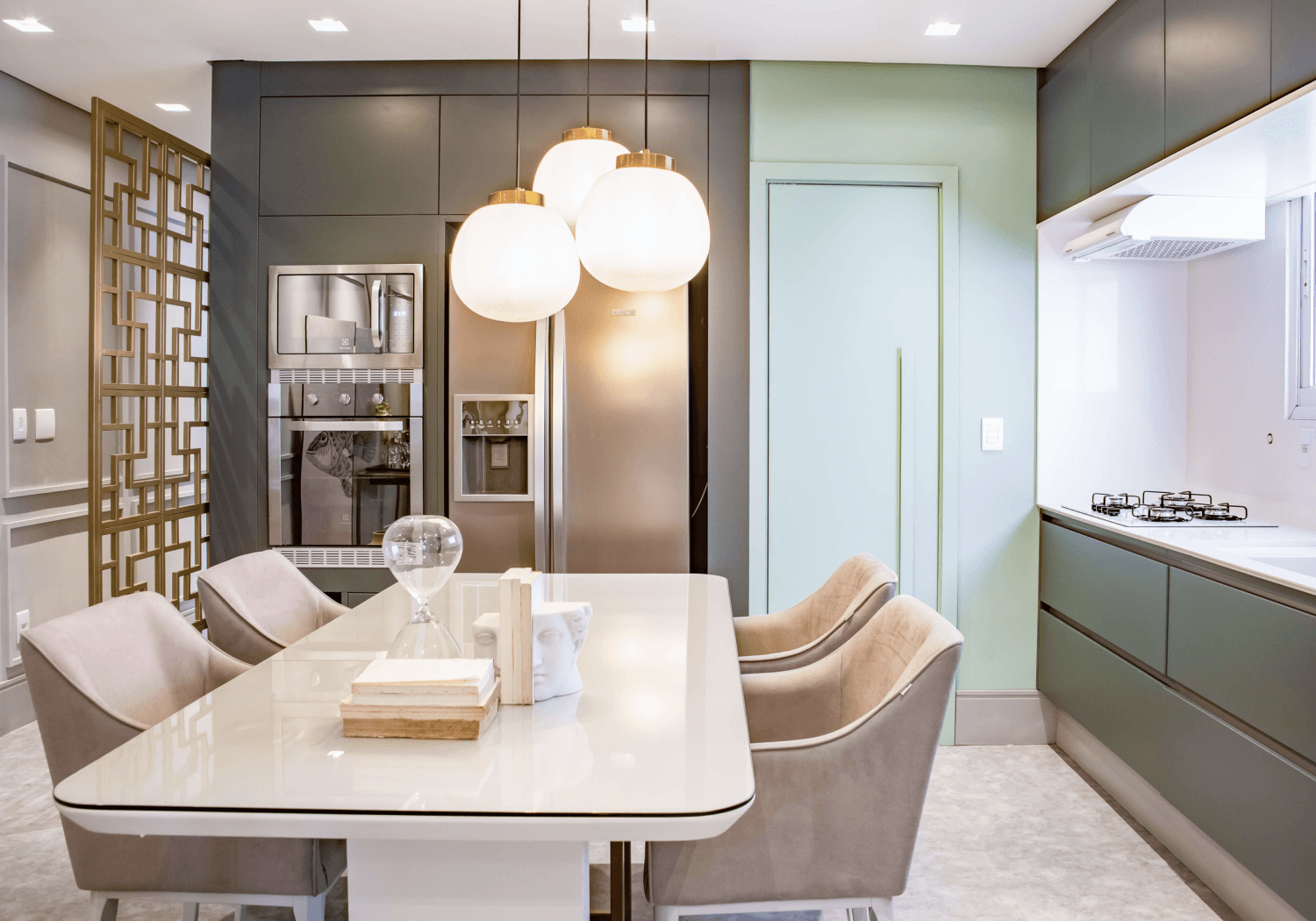 Elegant dining room in a luxury apartment with a glass dining table and pendant lighting.