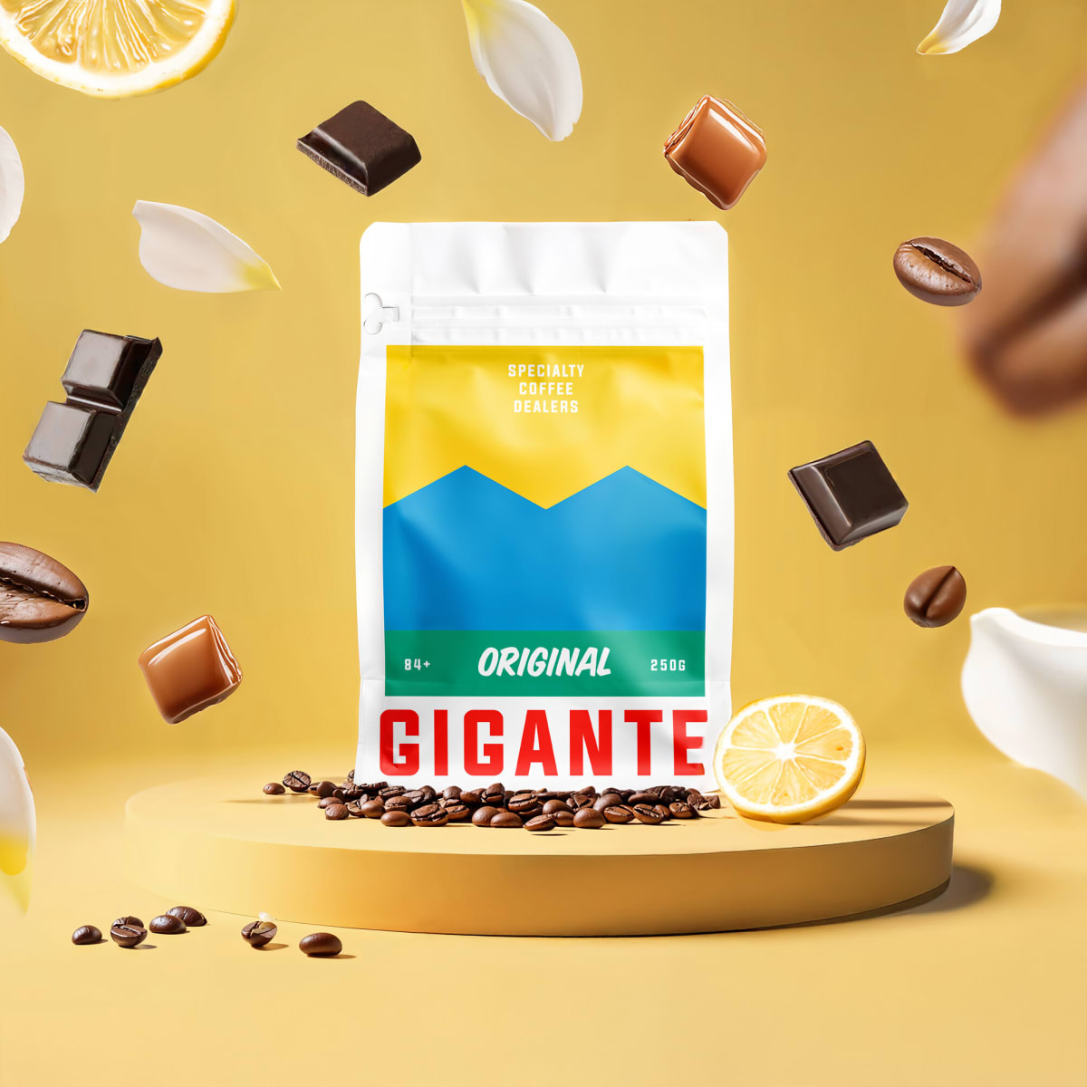 Gigante Original coffee bag on a yellow podium with chocolate, lemon and milk splash