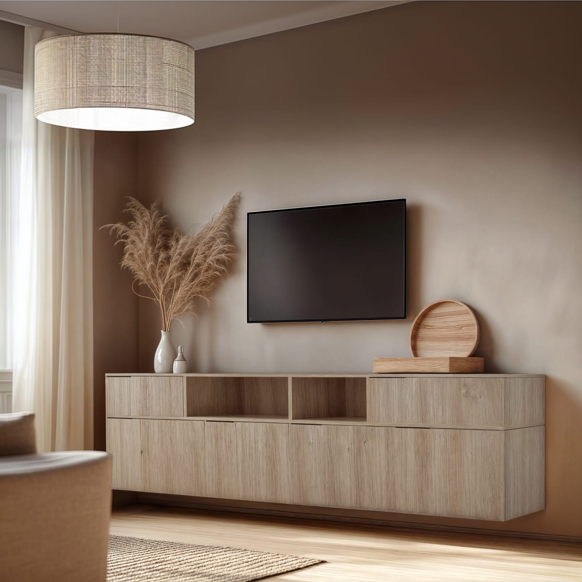 A floating oak TV rack under a wall mounted screen with pampas grass in a taupe room