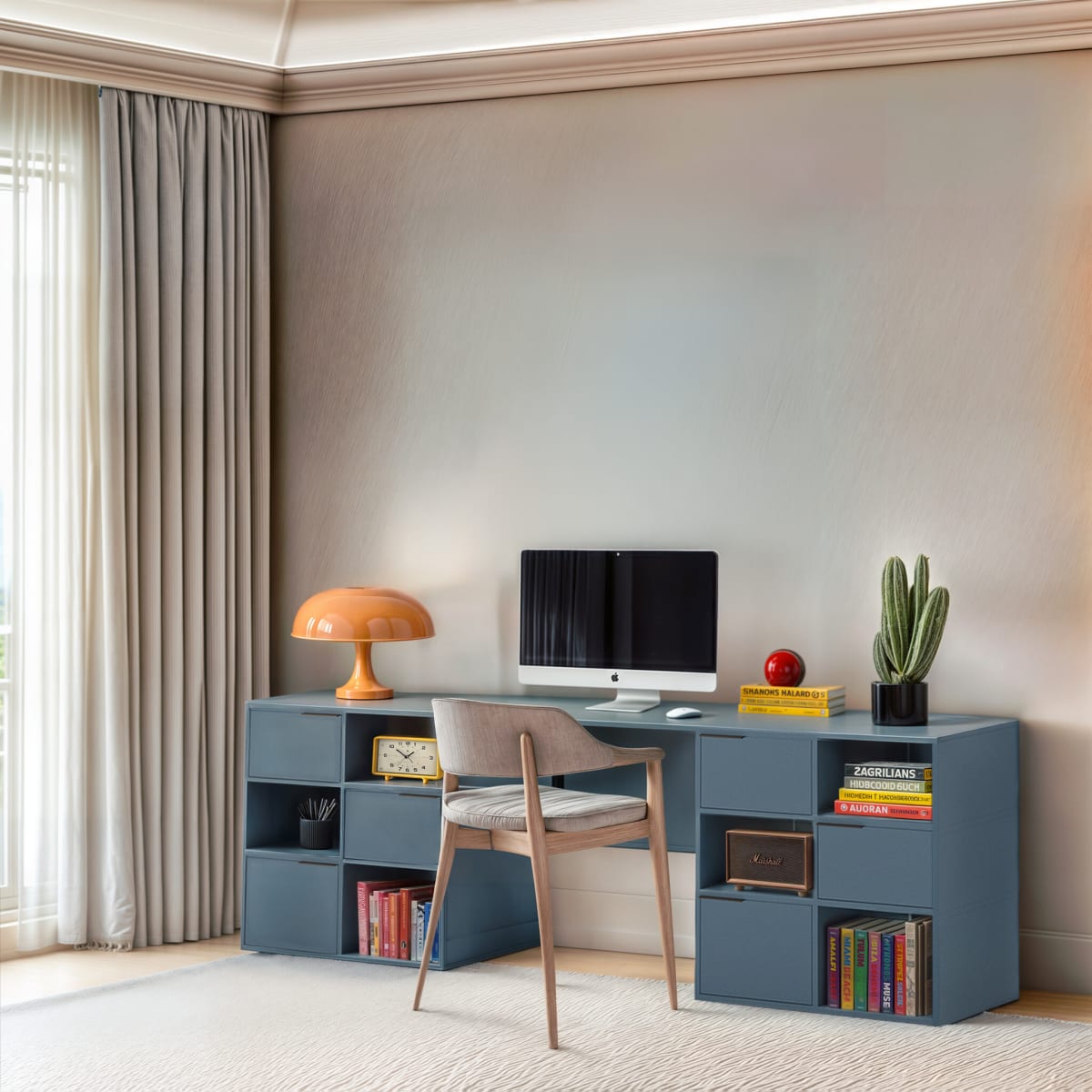 A blue Movêu desk unit with shelves, a computer and an orange lamp in a beige room