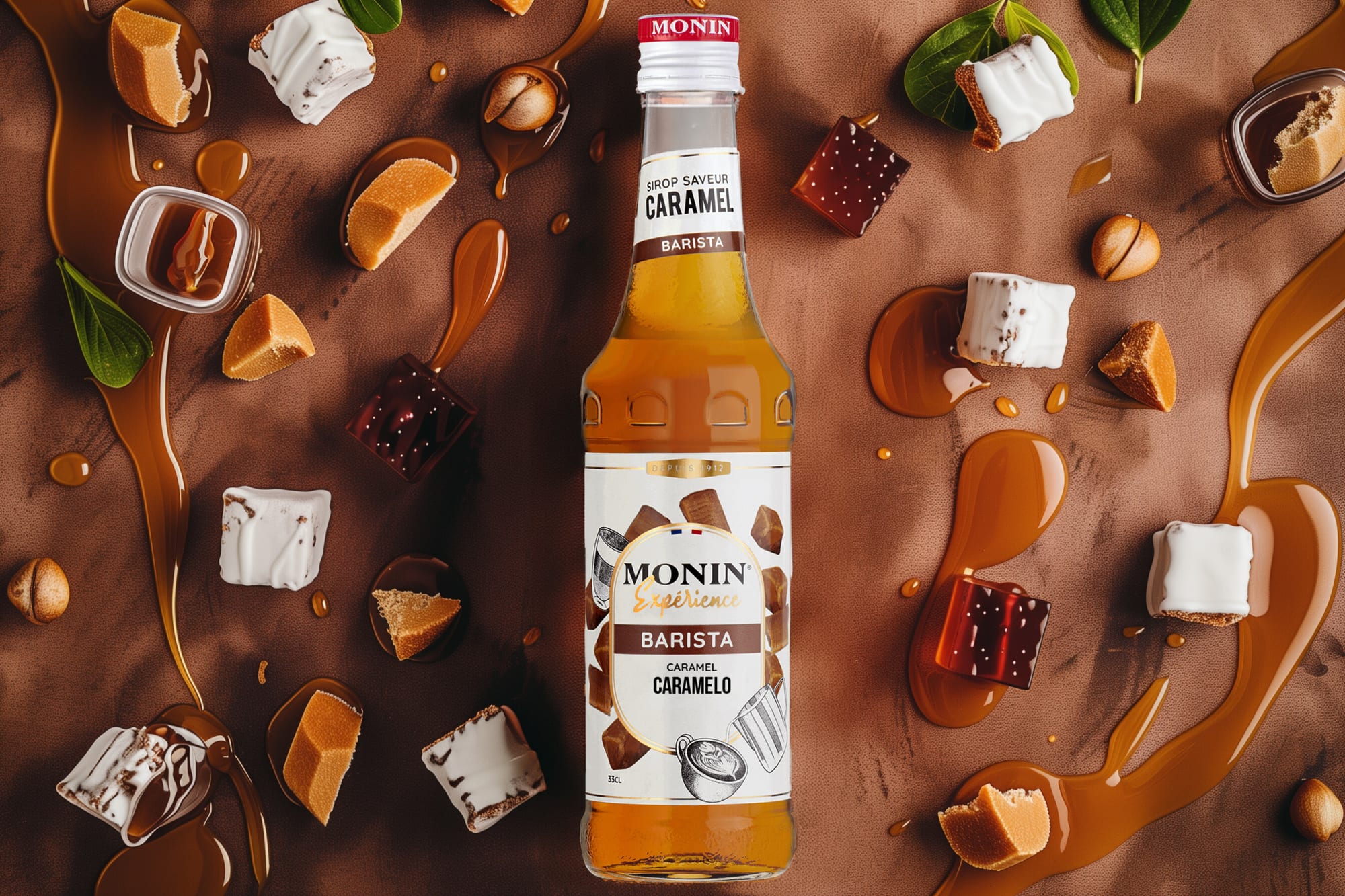 Monin caramel syrup bottle with caramel pools, marshmallows and toffee pieces on brown