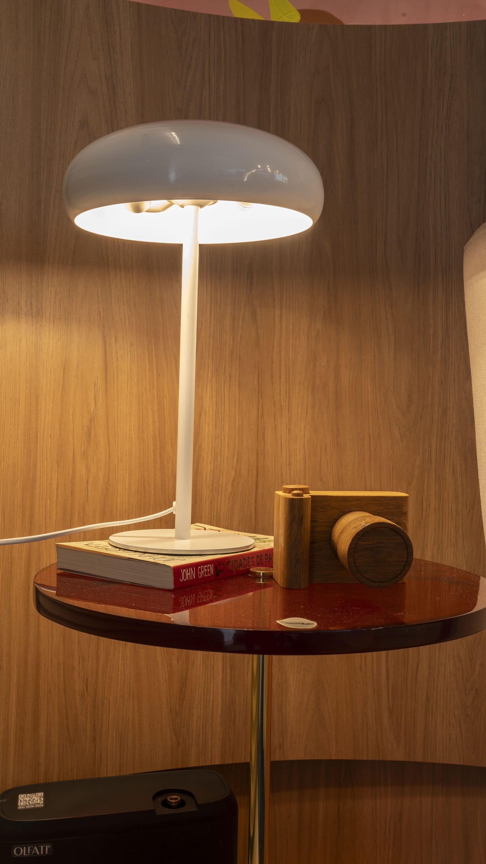 White mushroom table lamp on a glossy brown side table against oak panelling